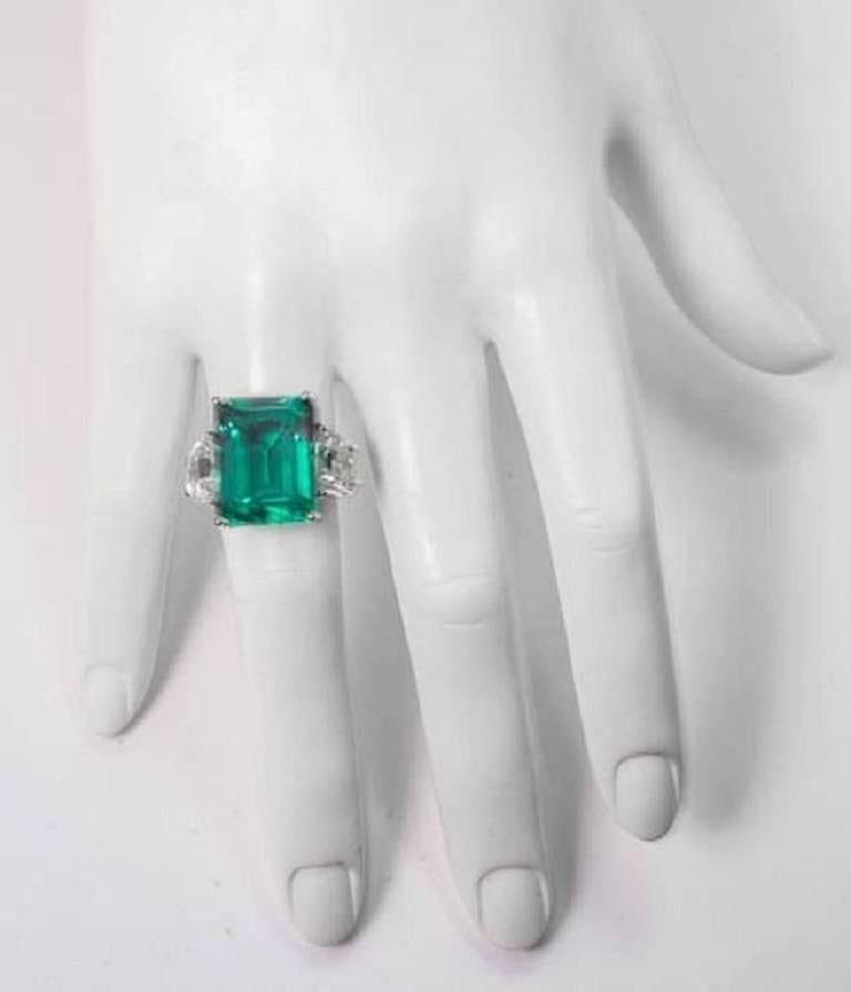 Magnificent  Faux Colombian Color 15 Carat Emerald Diamond Gold Ring.

Magnificent large faux gem green Colombian color 15 Carat emerald ring set with half-moon cubic zircons mounted in white and yellow gold. The faux emerald measures 