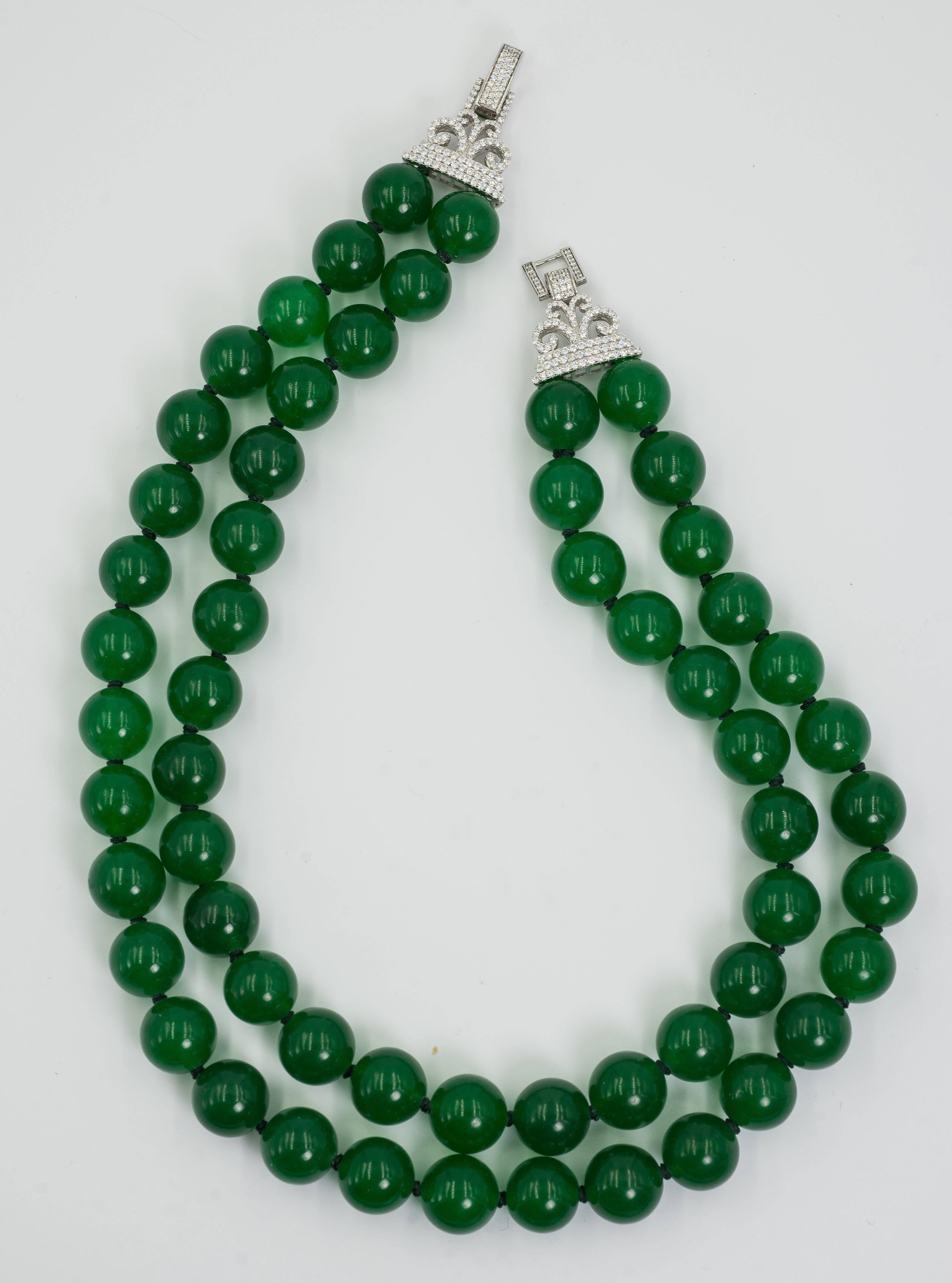 Elegant two strand faux Imperial Jade bead necklace made with 14mm Imperial Jade color natural stone beads beautifully strung to a wonderful 2'' faux diamond set sterling silver clasp. The necklace fits an 18'' neck and is 1'' deep.

Elegant and