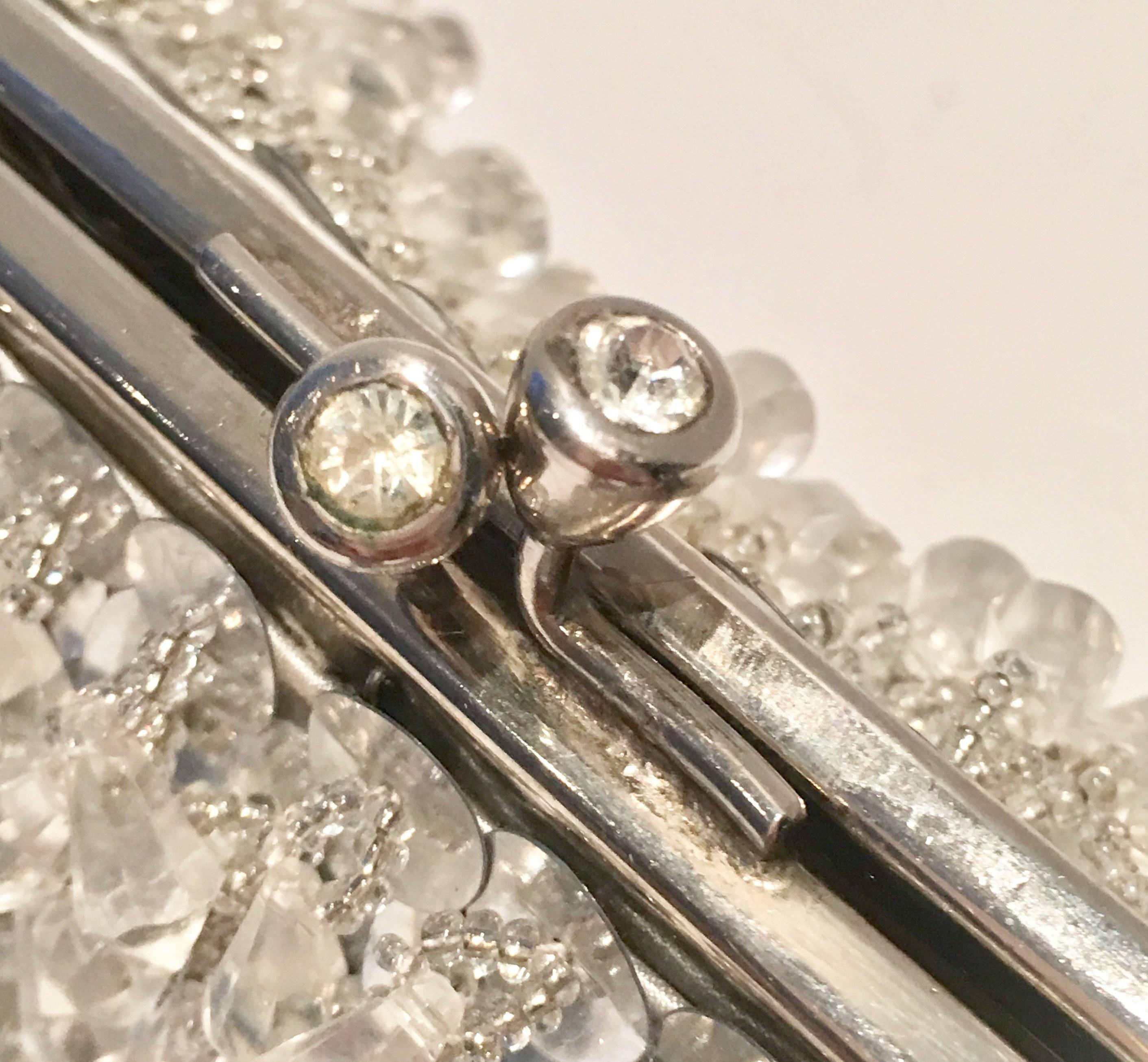 Mid-Century coveted clear chandelier hanging bead and silver metallic sequin hand bag. Features a silver plated metal frame with a snap top closure with two clear rhinestone gems, one in each snap. Includes a concealable silver plated snake chain