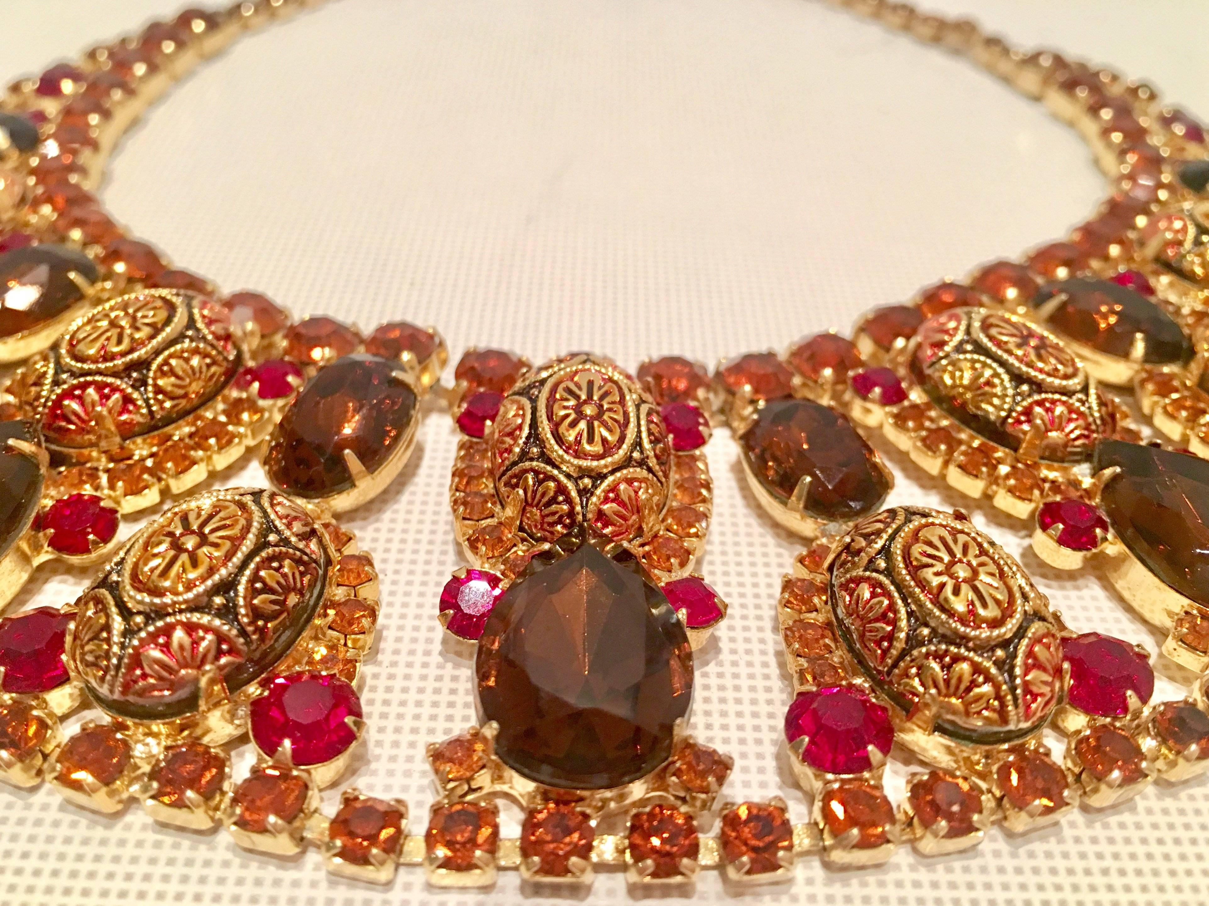 1960s Juliana by Delizza & Elster stunning Cleopatra collar necklace in topaz, citrine, pink sapphire and gold molded and carved art glass with Austrian crystal rhinestone gold plated metal scarab necklace. The most unique feature of this