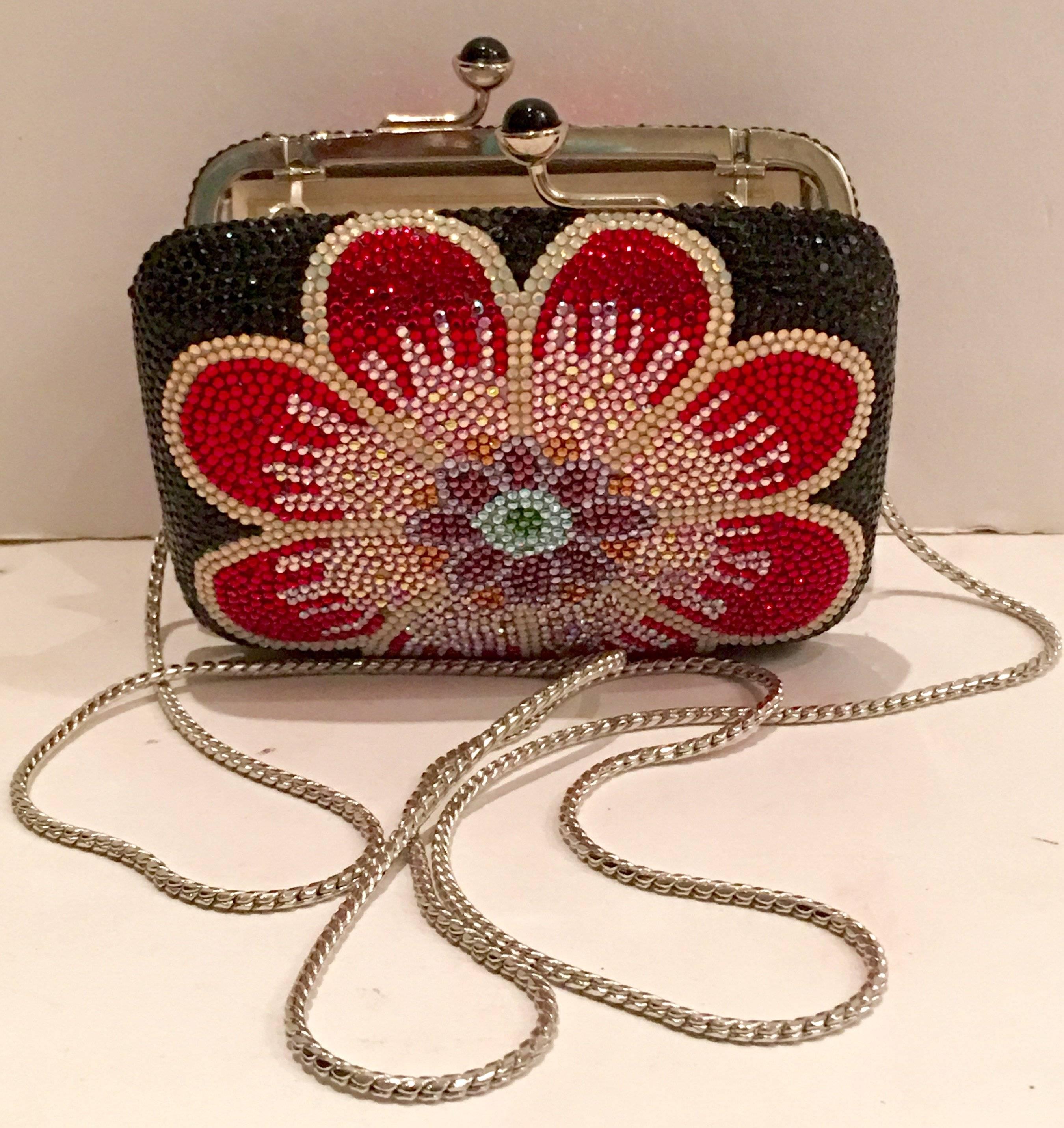 Rare Judith Leiber Swarofski crystal embellished flower Minaudiere evening bag. This special and rare flower motif collectors evening bag from famed artisan Judith Leiber features a large central flower in ruby red, pink, amethyst, orange, white and