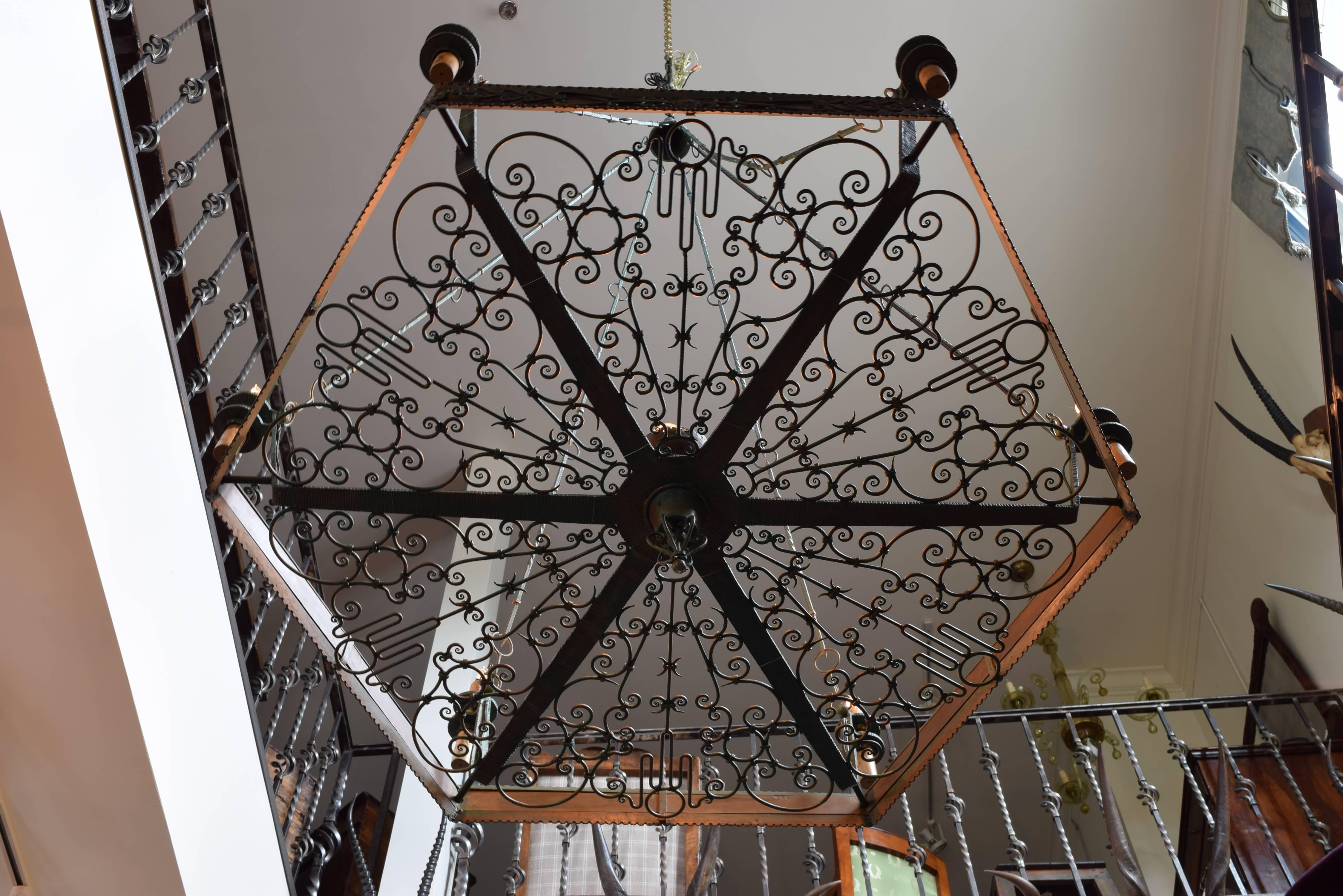 Seven-light chandelier of hexagonal form and having detailed decorative ironwork, formerly hanging in the Castello Angioino di Parabita, Lecce, Italy.  Maker is Antonio D' Andrea (Lecce 1908-1955).