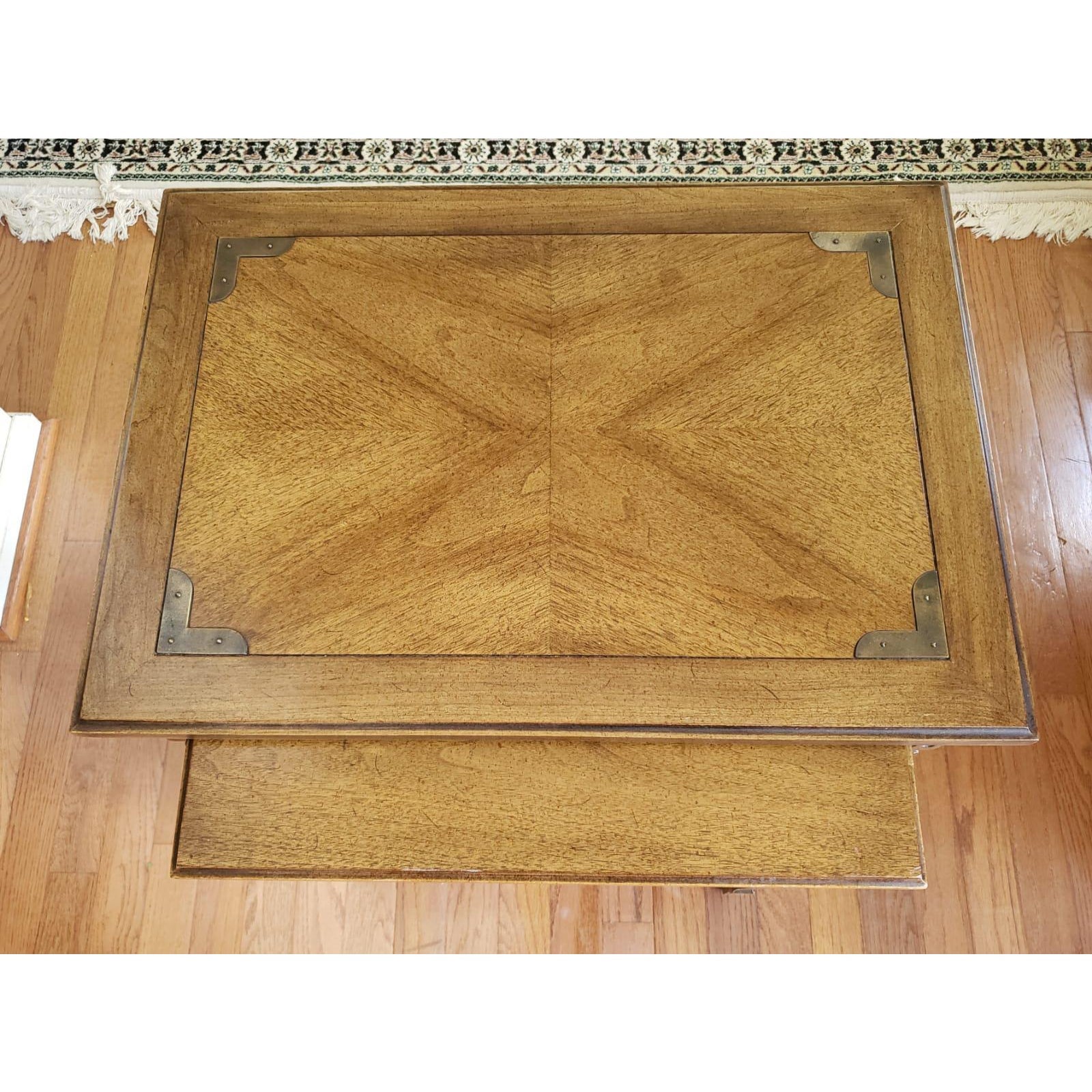 Campaign style walnut nesting tables. Great condition. measure 24W x 17D x 21.25H for the bigger table and 18.5W x 14.5D x 20.25H for the smaller table. Excellent vintage condition.
 