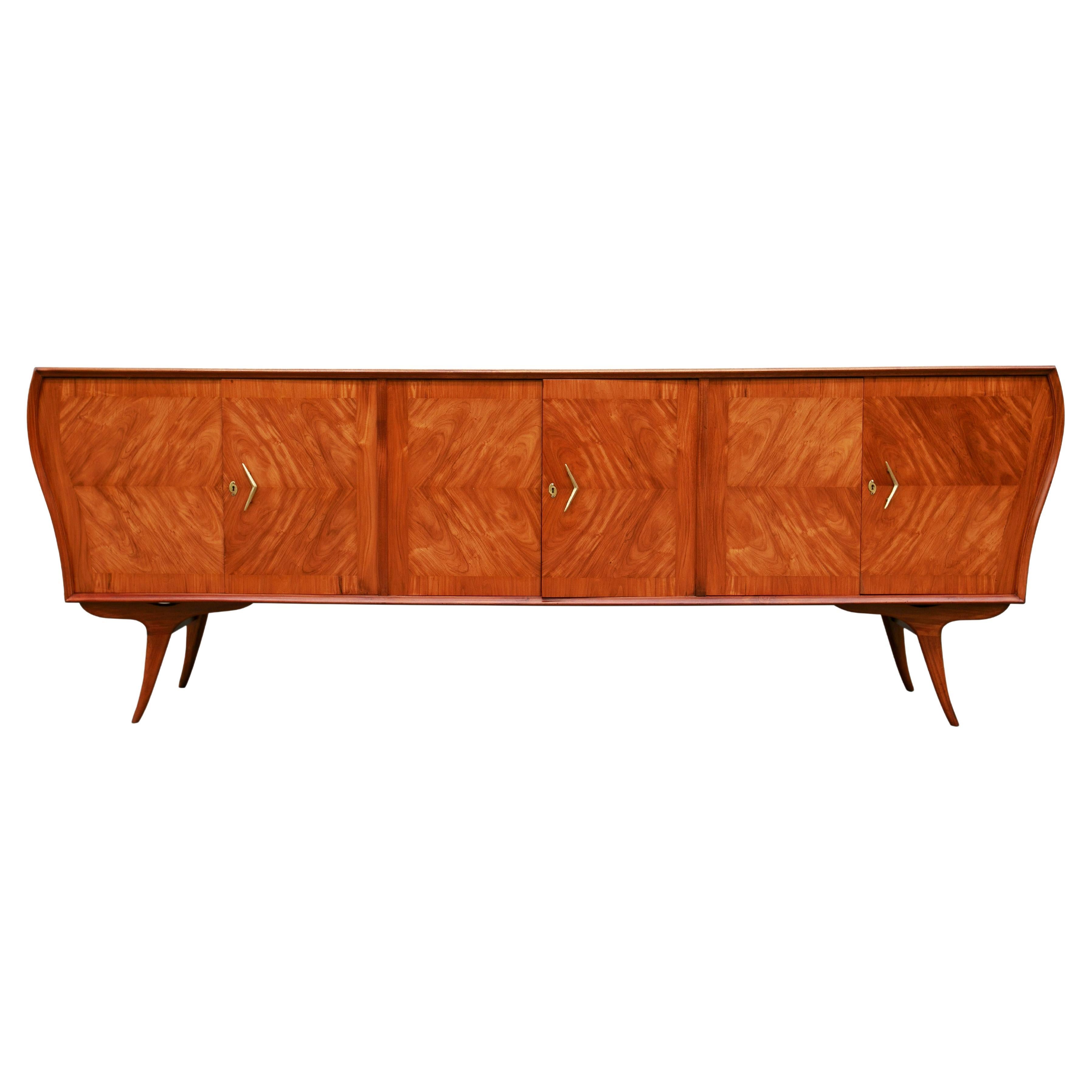 Available today, this one-of-a-kind Mid-Century Modern Credenza in Caviuna Hardwood designed by Ando in the fifties is the FIND of the year and is nothing less than spectacular.

The credenza is made of solid Caviuna wood and features four curved