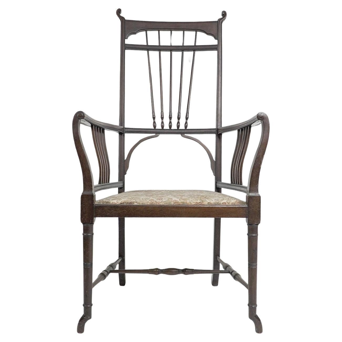 Henry W Batley attr. An Aesthetic Movement walnut armchair with sinuous touches. For Sale