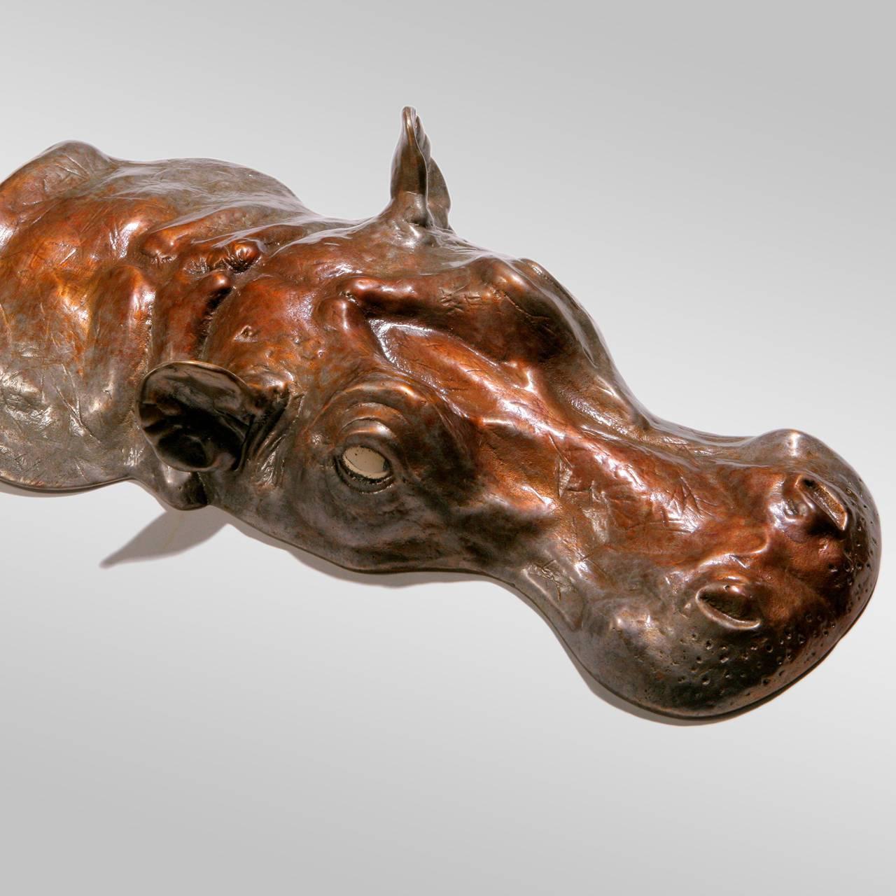 Small cast bronze hippopotamus sculpture with hand-patinated finish. This unique two-piece art object, signed and dated by the artist, can be displayed on a table or on the floor. Larger size also available.