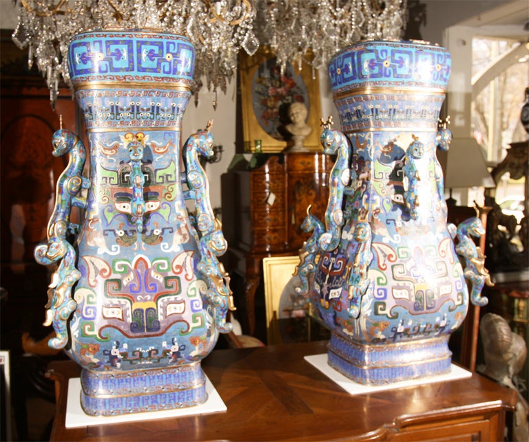 Very large pair of Cloissone vases with covers and attached animal form handles and decoration. Feet are of the same animal but not in photo (discovered later)