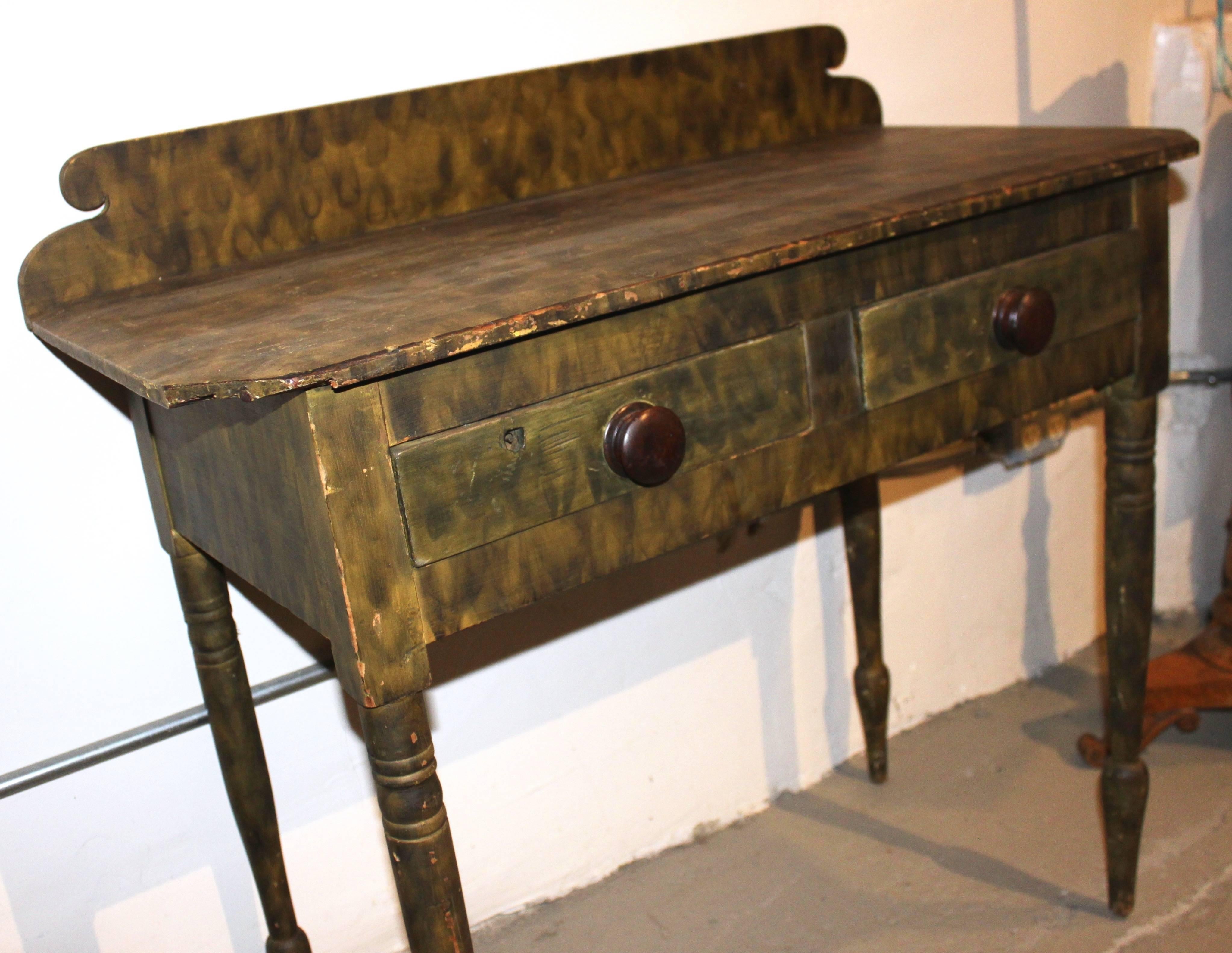 Minor imperfections and repairs. Painted table is American early 19th century which then is smoke decorated (using candle smoke) to give the streaking or graining effect.

Original paint.