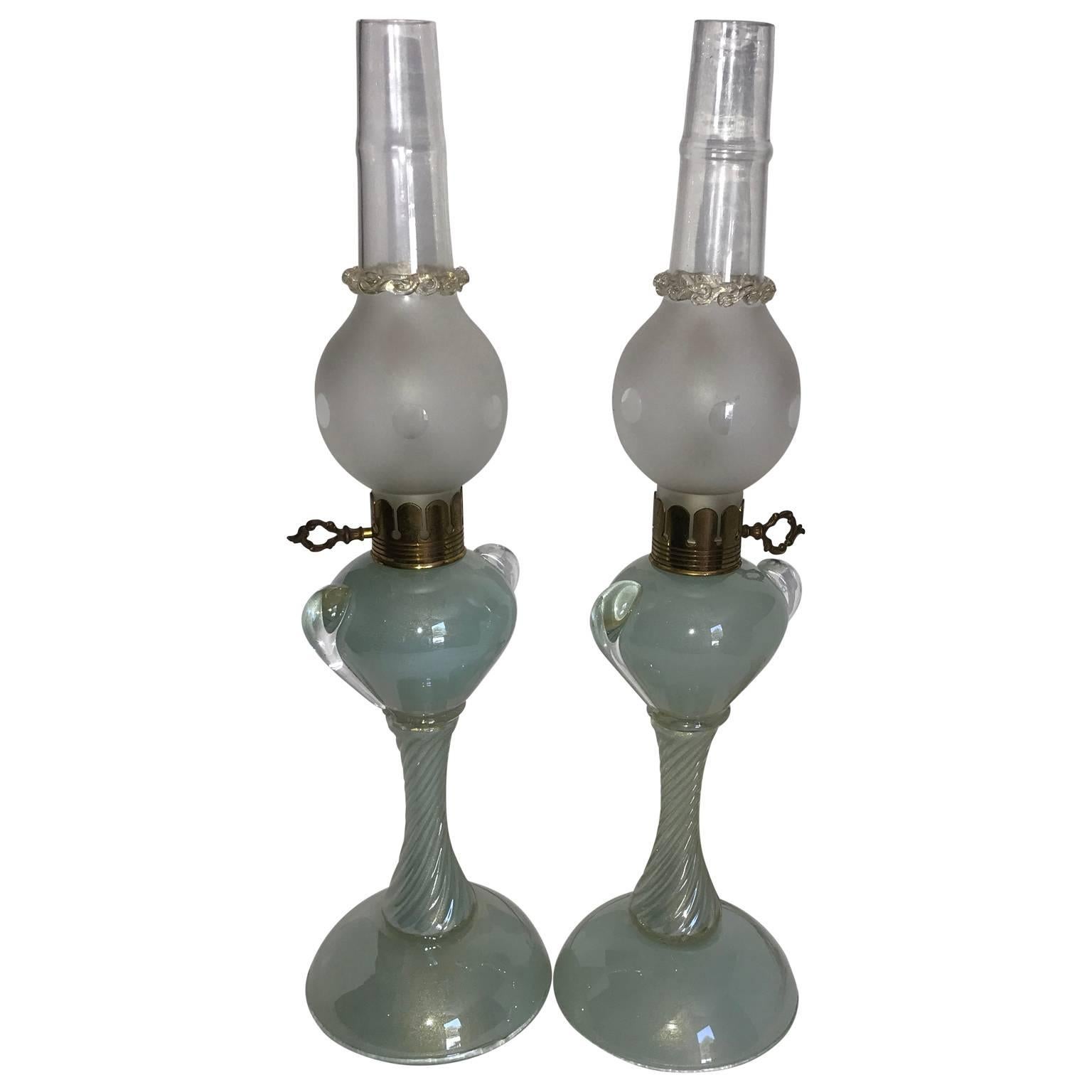 Italian pair of lamps in a luster turquoise glass and brass hardware with frosted glass shades. Original wire and switch in good working condition. New wiring and switches can be installed at no cost on demand.
       