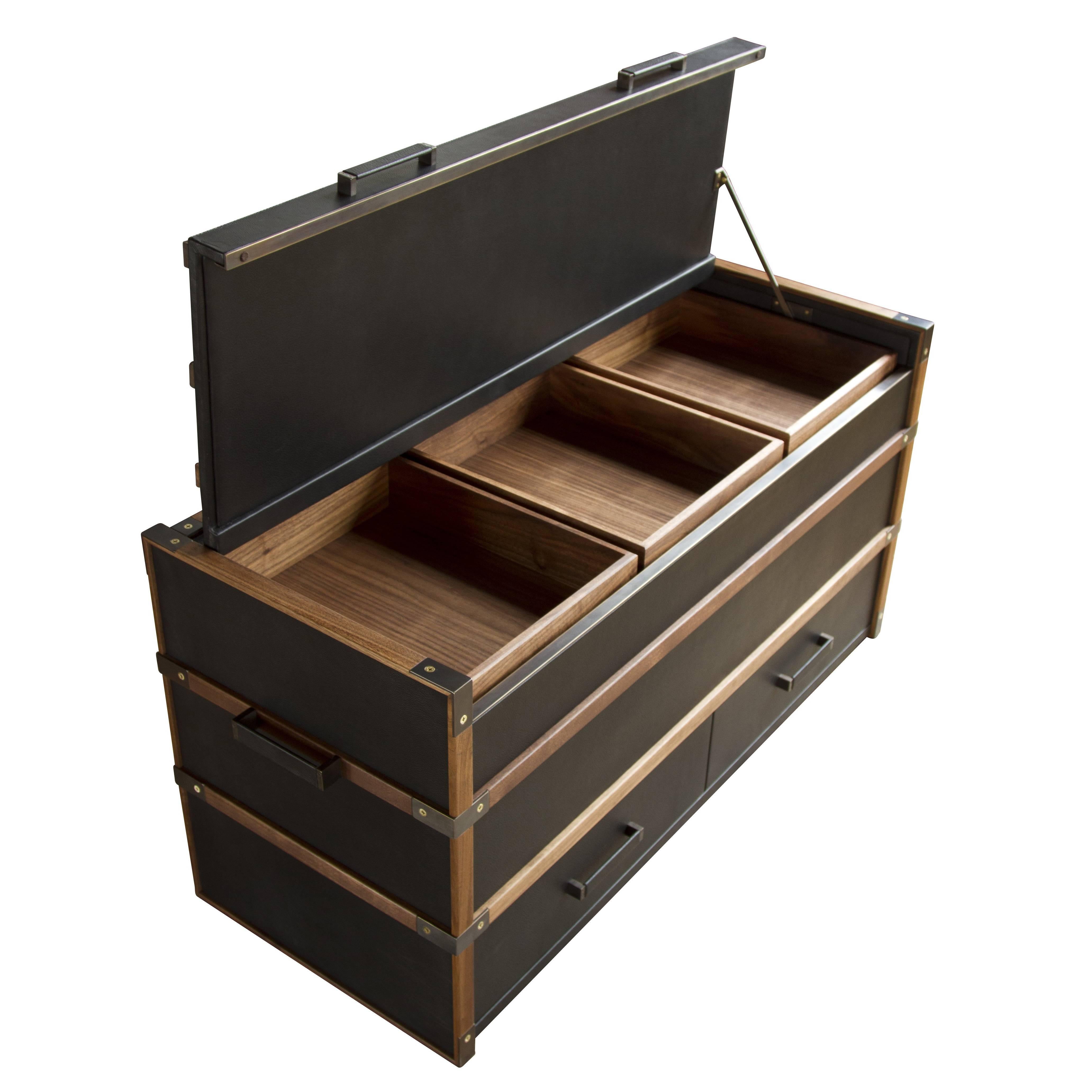 The Collingwood trunk is the first variation that we’ve made of the Collingwood Falconer’s Kit. The trunk has a top opening lid with three removable boxes with storage underneath and two drawers. The trunk is clad with hand-stitched Moore & Giles: