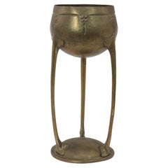 WMF. A hand beaten brass chalice, the bowl raised on three organic supports.