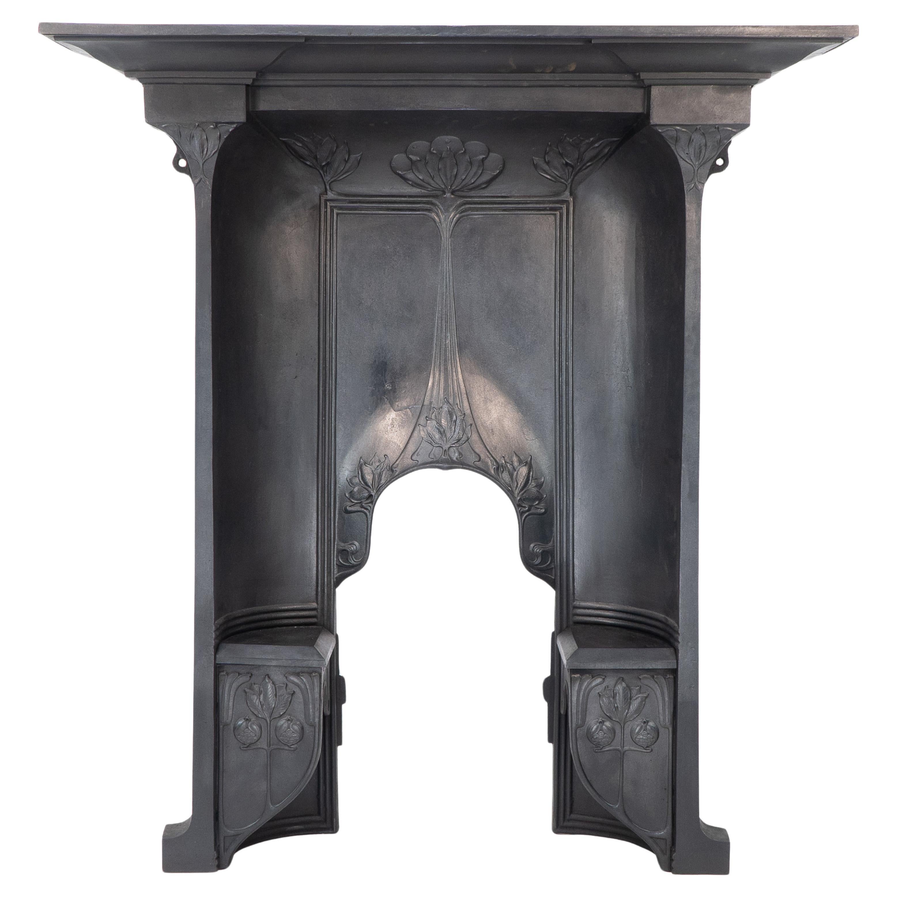 Arts & Crafts cast iron fireplace with curved sides & stylized floral decoration For Sale