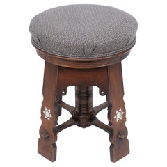 Antique Liberty and Co attri. A rare Moorish walnut revolving stool with Moorish arches