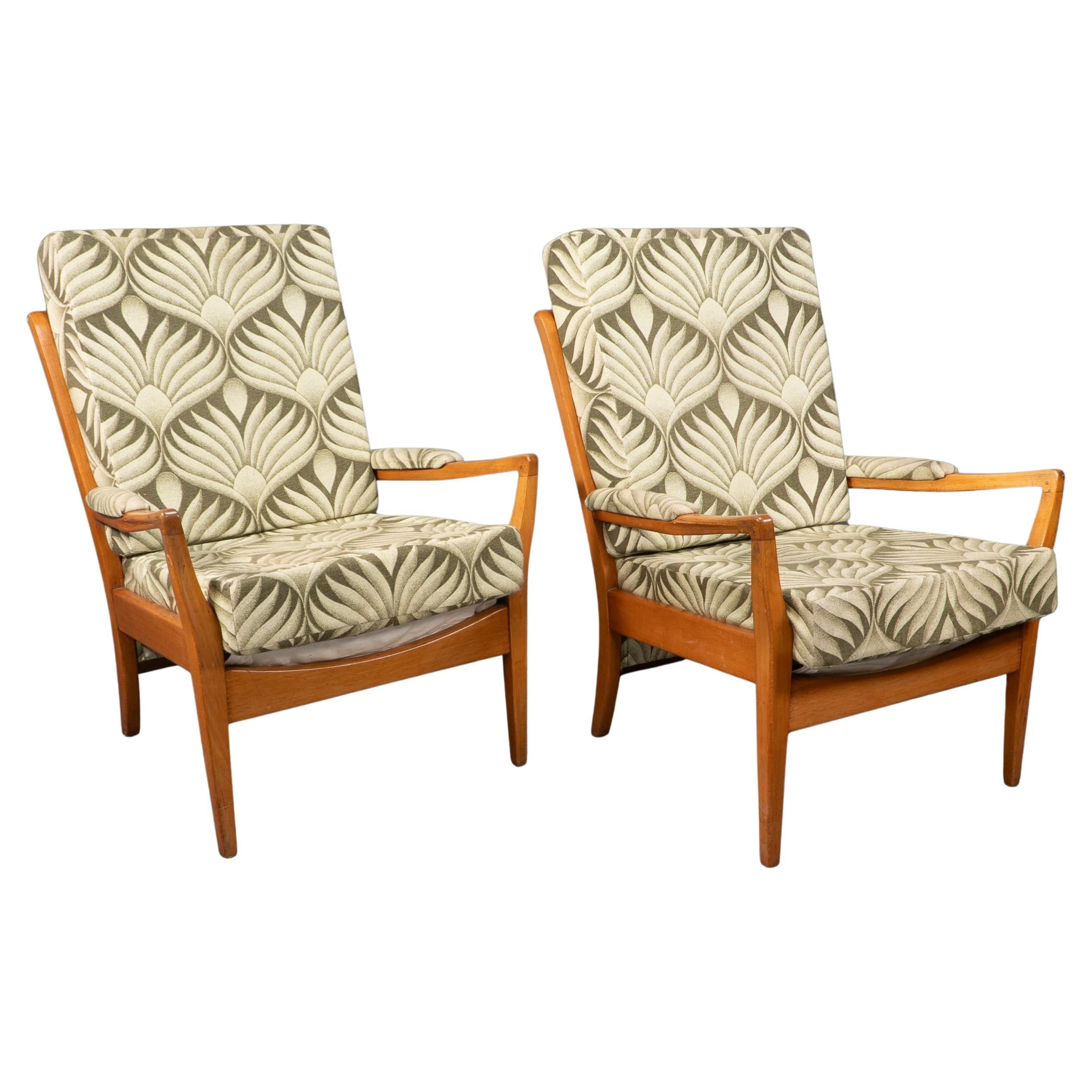 A pair of Mid-Century beech armchairs with outswept arms