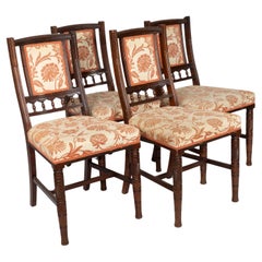 Antique Bruce Talbert attributed. A set of four Aesthetic Movement walnut dining chairs