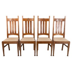 Antique E A Taylor for Wylie & Lochhead. A set of four Arts and Crafts oak dining chairs