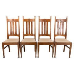 E A Taylor for Wylie & Lochhead. A set of four Arts and Crafts oak dining chairs