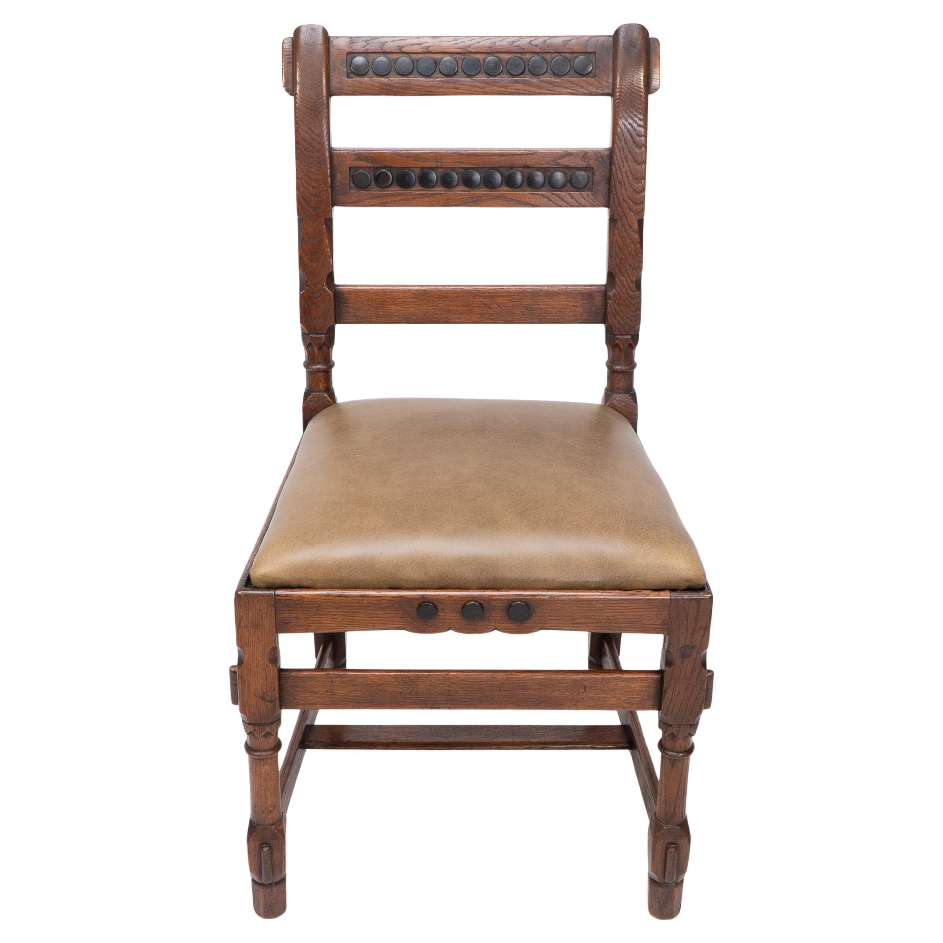 J P Seddon attributed. An Aesthetic Movement oak side chair with ebonized circles to the backrests and carved decoration with through exsposed tenonsn joints. Seat Height: 45 cm
