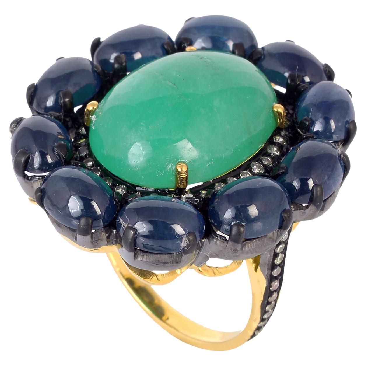 Oval Shaped Emerald Cocktail Ring Accented With Blue Sapphire & Diamonds For Sale