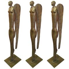 Trio of Elongated Bronze Angel Form Candlesticks