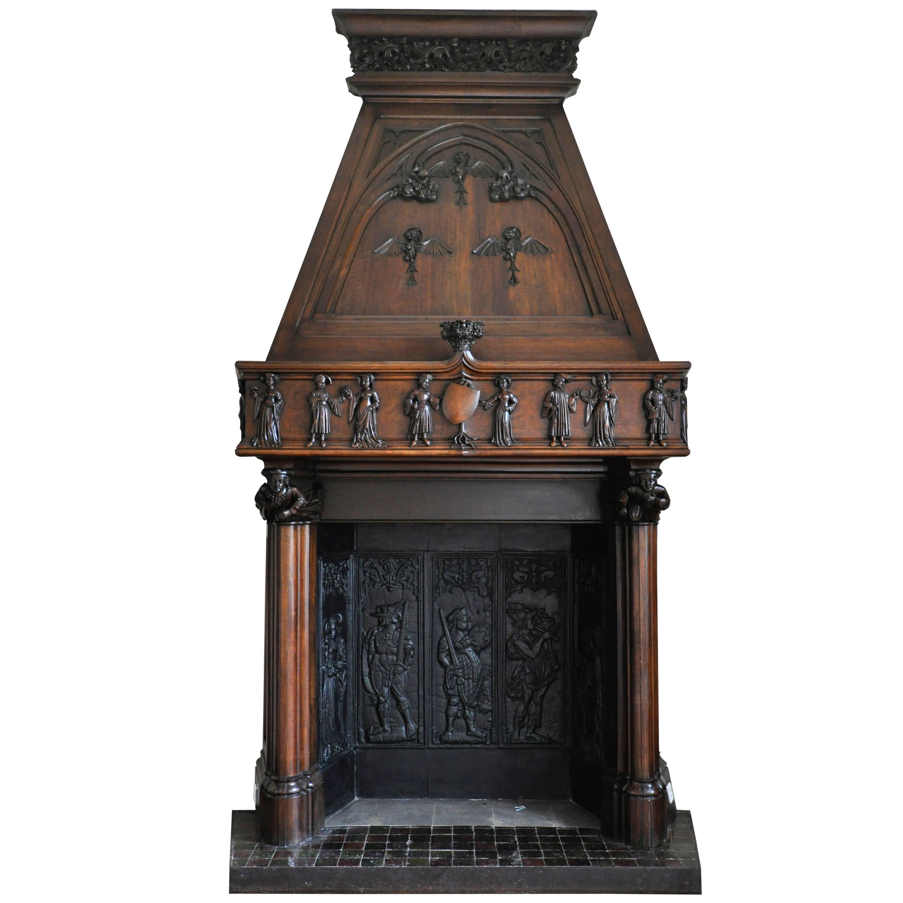 Neo-Gothic style carved walnut fireplace with hood, 19th c. For Sale