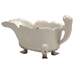 English delftware pottery sauce boat with three feet and lion form handle. mid 1
