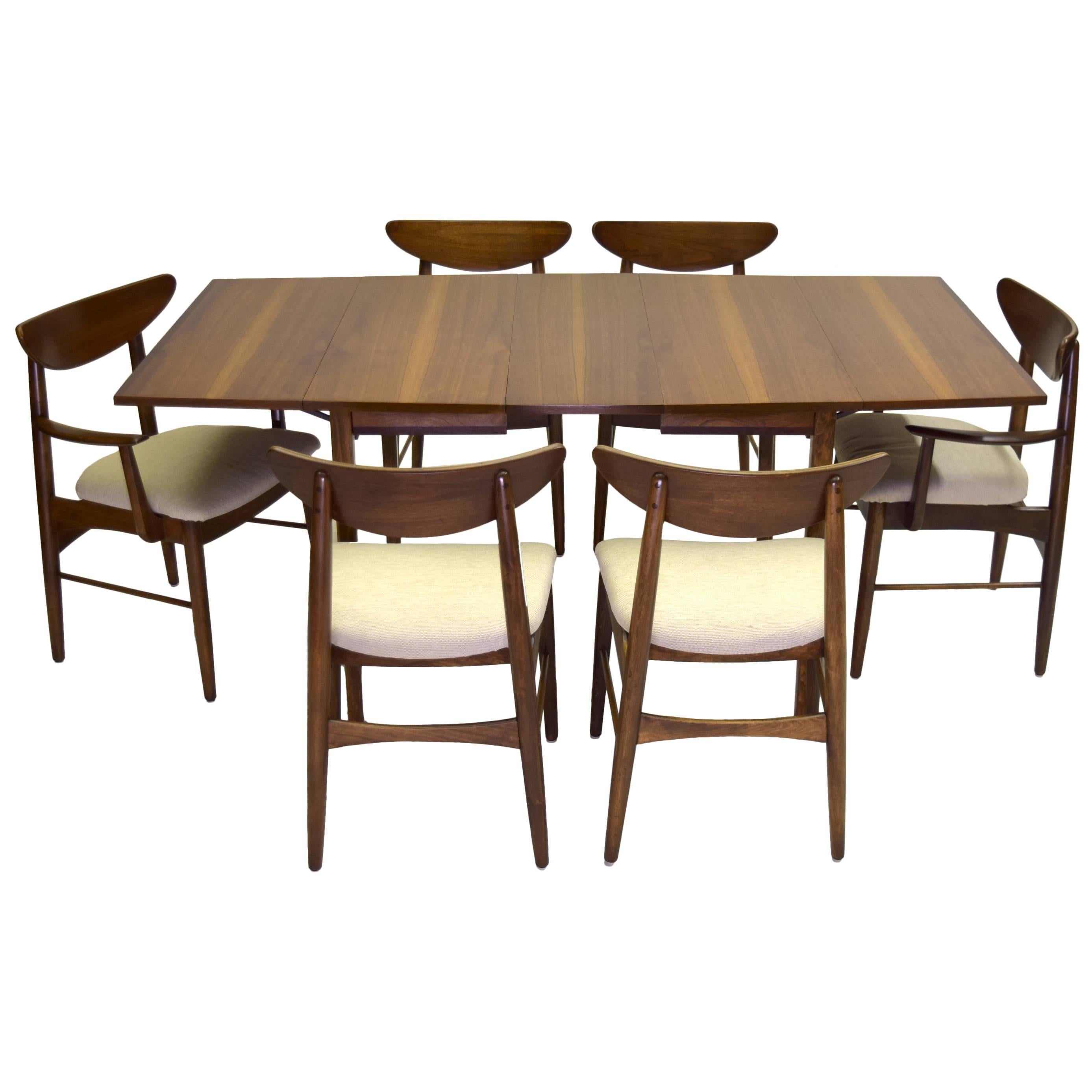 Designed by Pierre Debs for Stanley Furniture in the 1960s.

This listing is for 2 captain / arm chairs, 4 regular chairs, dining table with extension leaf and the china cabinet / hutch buffet, a complete set. This design is exceptionally well