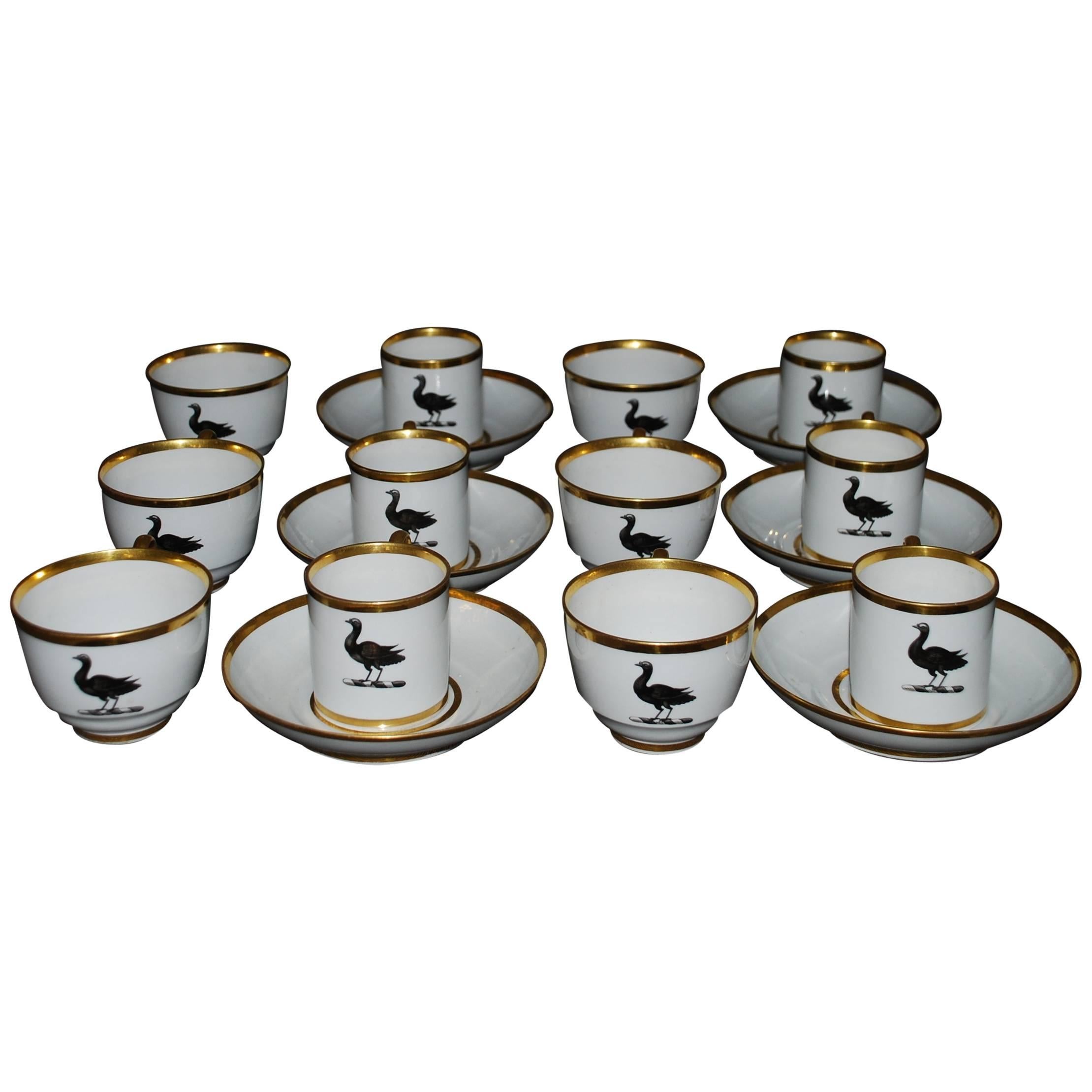 Set of six porcelain bird teacup trios. Strikingly modern looking antique set of six BFB Worcester trios of six teacups and six coffee cups with six shared saucers of elegant form in white with gilt rims and Empire handle centering on a black goose