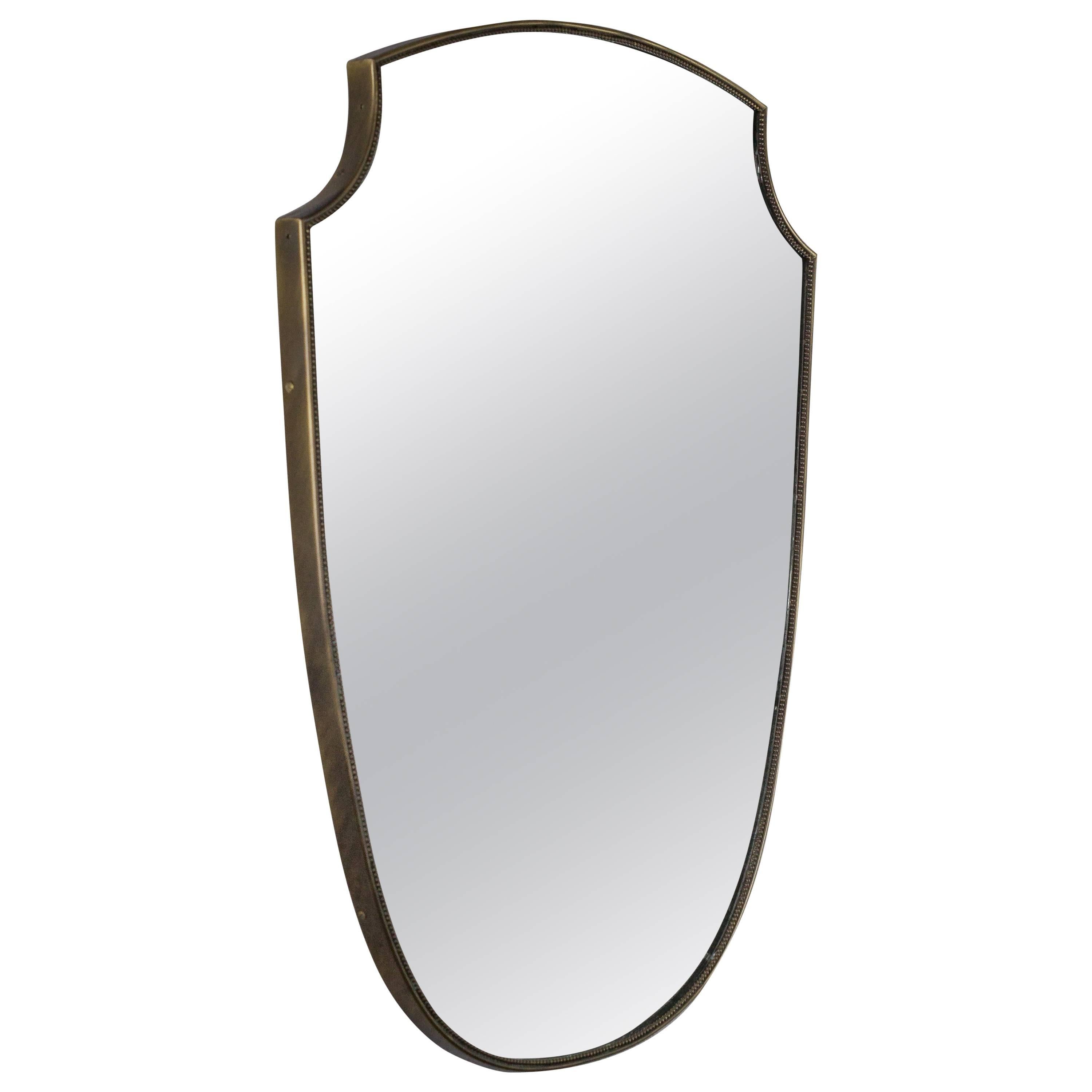 Elegant brass framed Italian mirror in a shield design with a braided border.