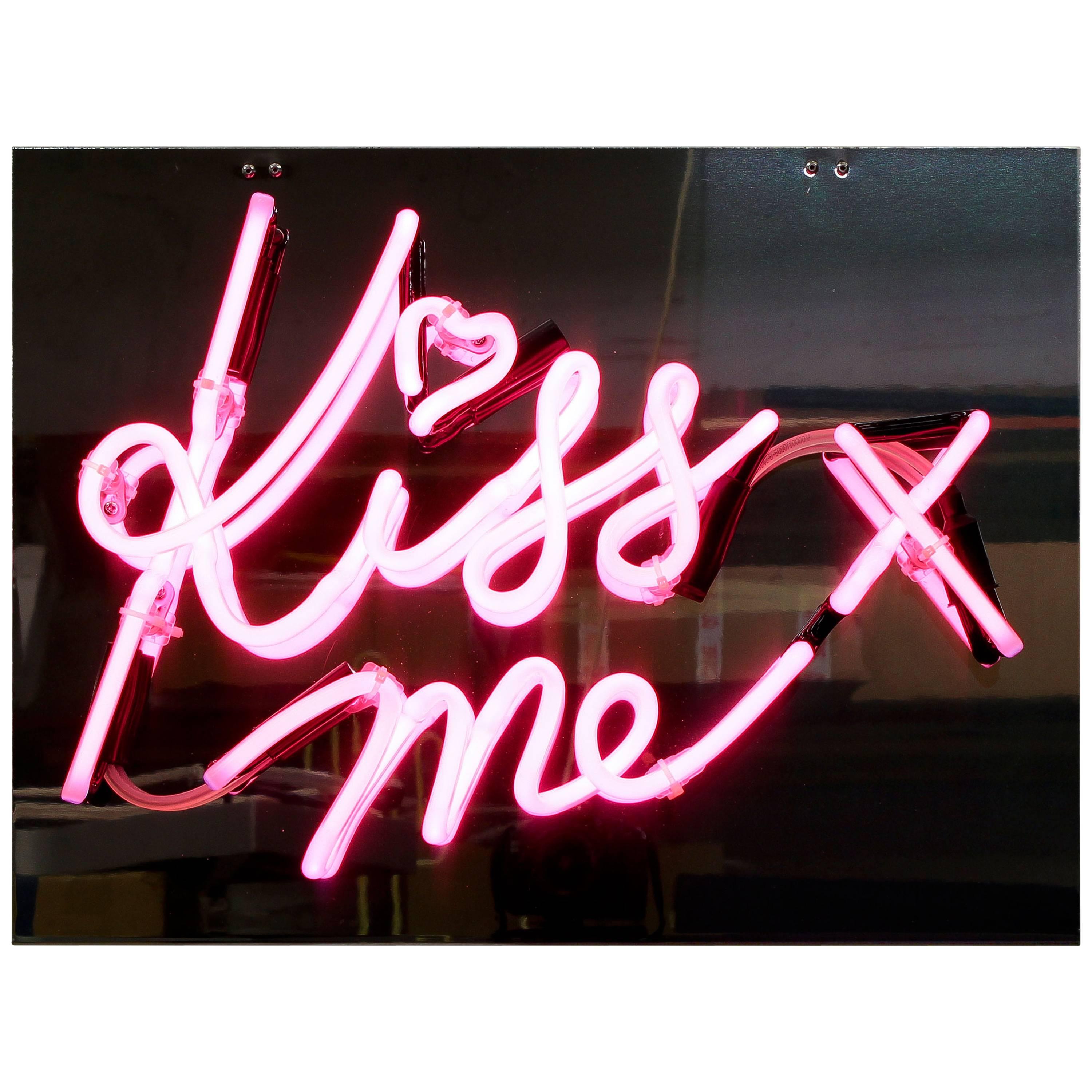 "Kiss Me" in Pink Neon on Mirrored Acrylic Backing For Sale