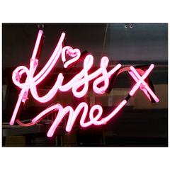 "Kiss Me" in Pink Neon on Mirrored Acrylic Backing
