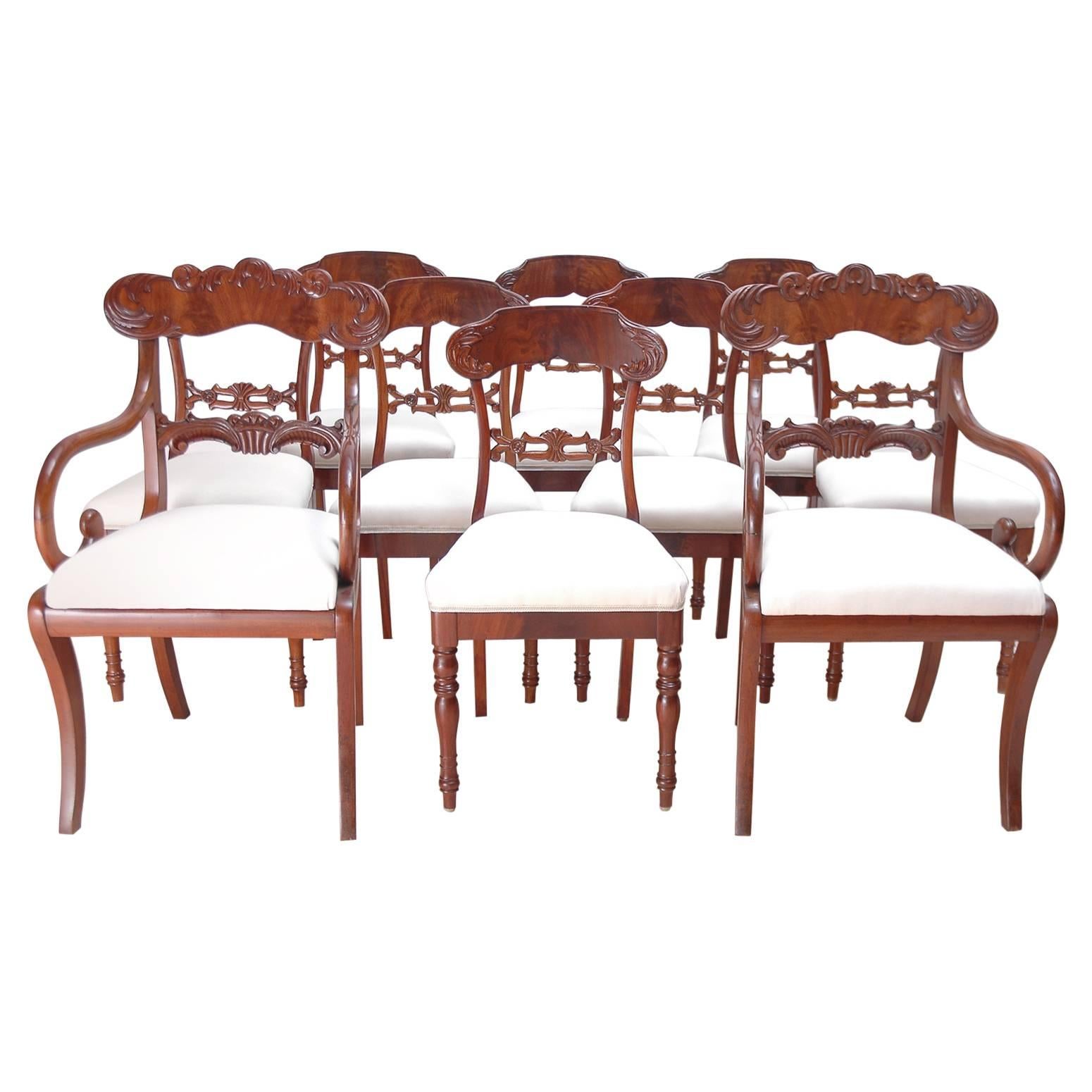 A set of ten Karl Johan dining chairs comprising of eight side chairs and a pair of armchairs in West Indies mahogany with carved back splat and crest rail with foliate design of acanthus leaves. Side chairs feature turned front legs with saber rear