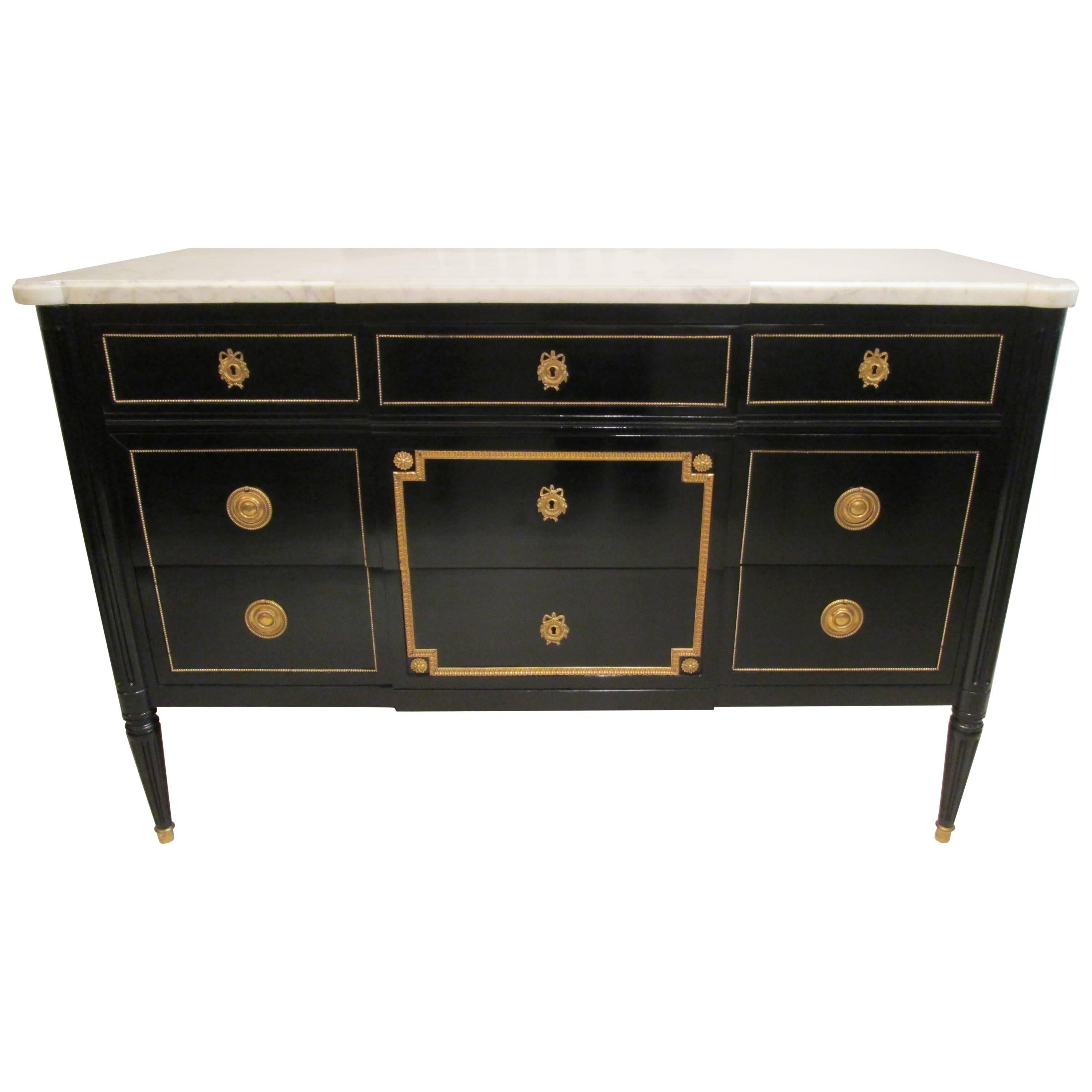 Maison Jansen  bronze- mounted, ebonized commode with marble top with five pull-out drawers,
circa 1940s, 1950's
