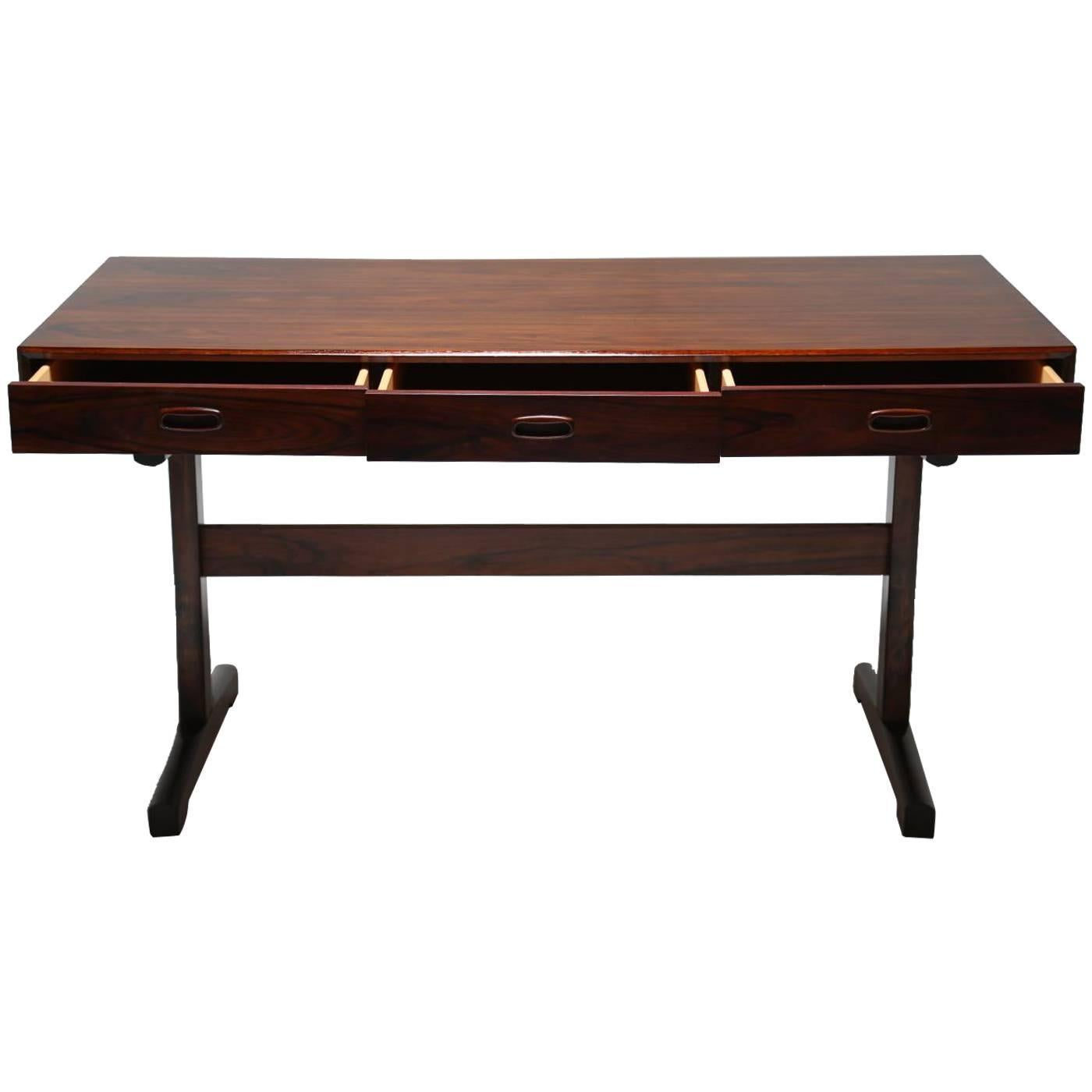 A really beautiful Scandinavian three-drawer desk in rosewood by Ganddal Mobelfabrikk. There are three drawers across the front and the rosewood top with three drawers, it is unbelievably beautiful in person and in superb original condition.