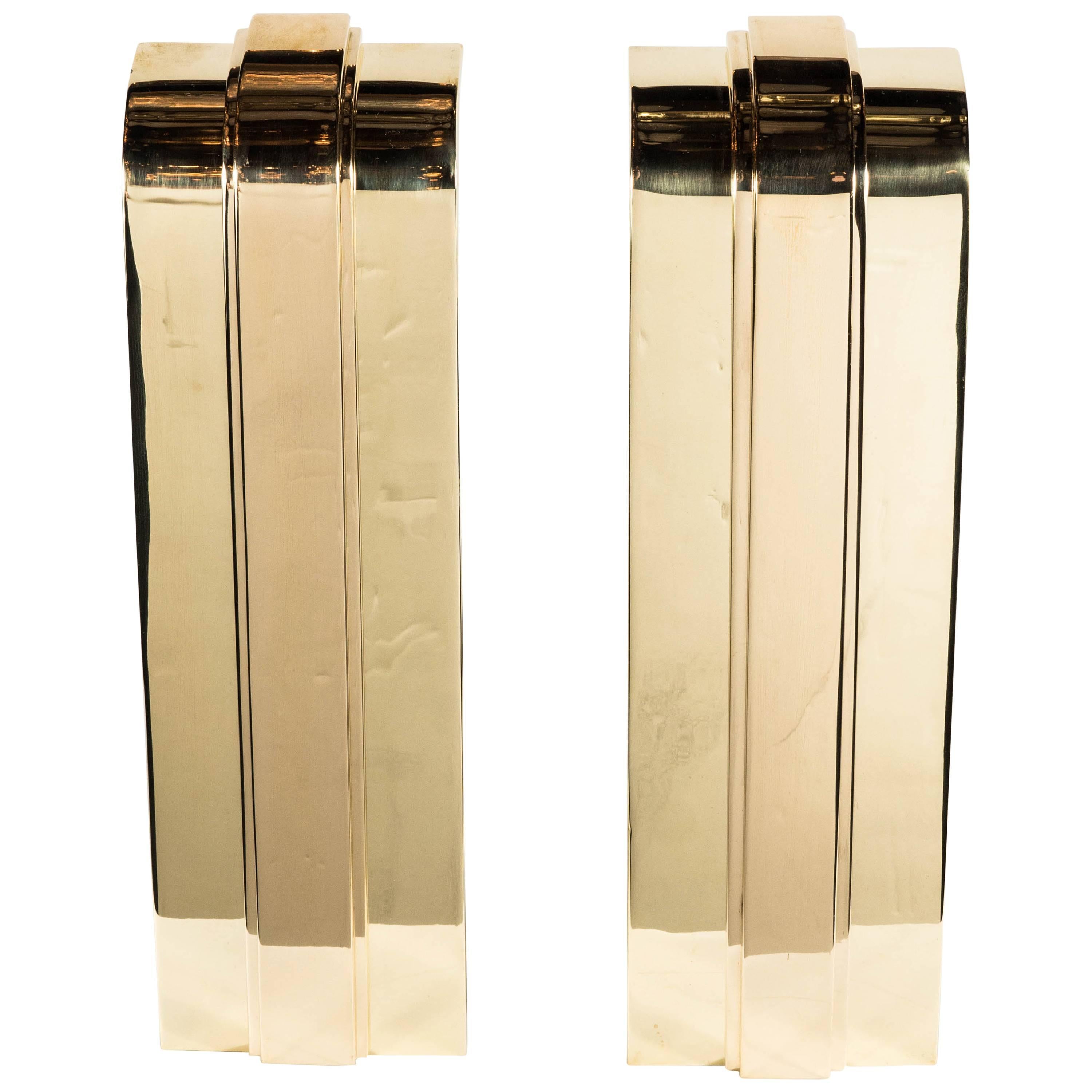 These custom Art Deco style andirons feature a stepped streamlined design with a inverted curve at the top of the structure. They are fully customizable in terms of the dimensions and finish options include polished, brushed or antiqued nickel or