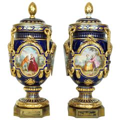 Magnificent Pair of Blue Sevres Style Covered Urns with Court Scenes