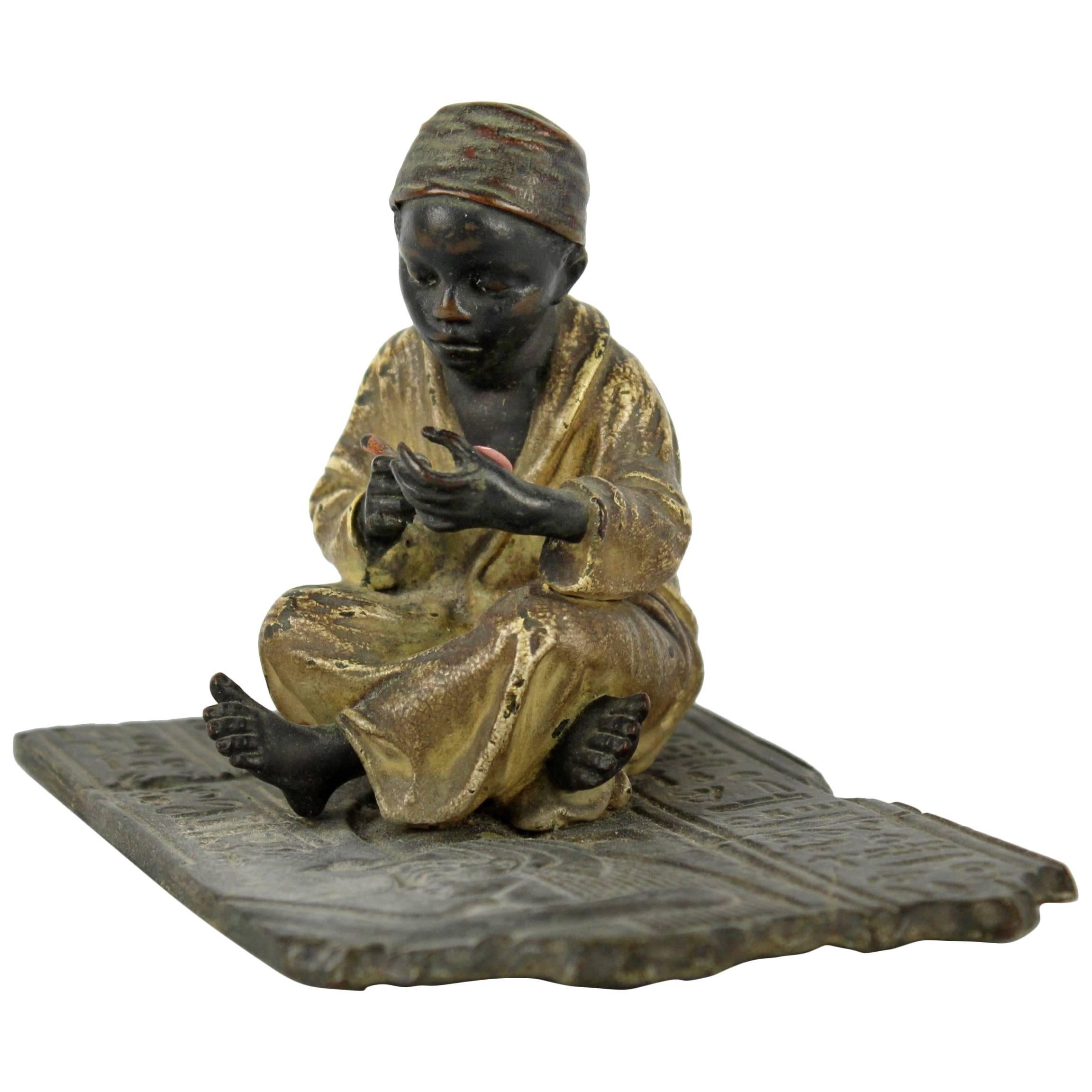 Cold Painted Orientalist Bronze Sculpture of a Seated Arab Boy by F. Bergmann