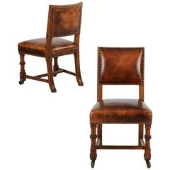 Pair of English Antique Leather and Carved Oak Side Chairs, circa 1900