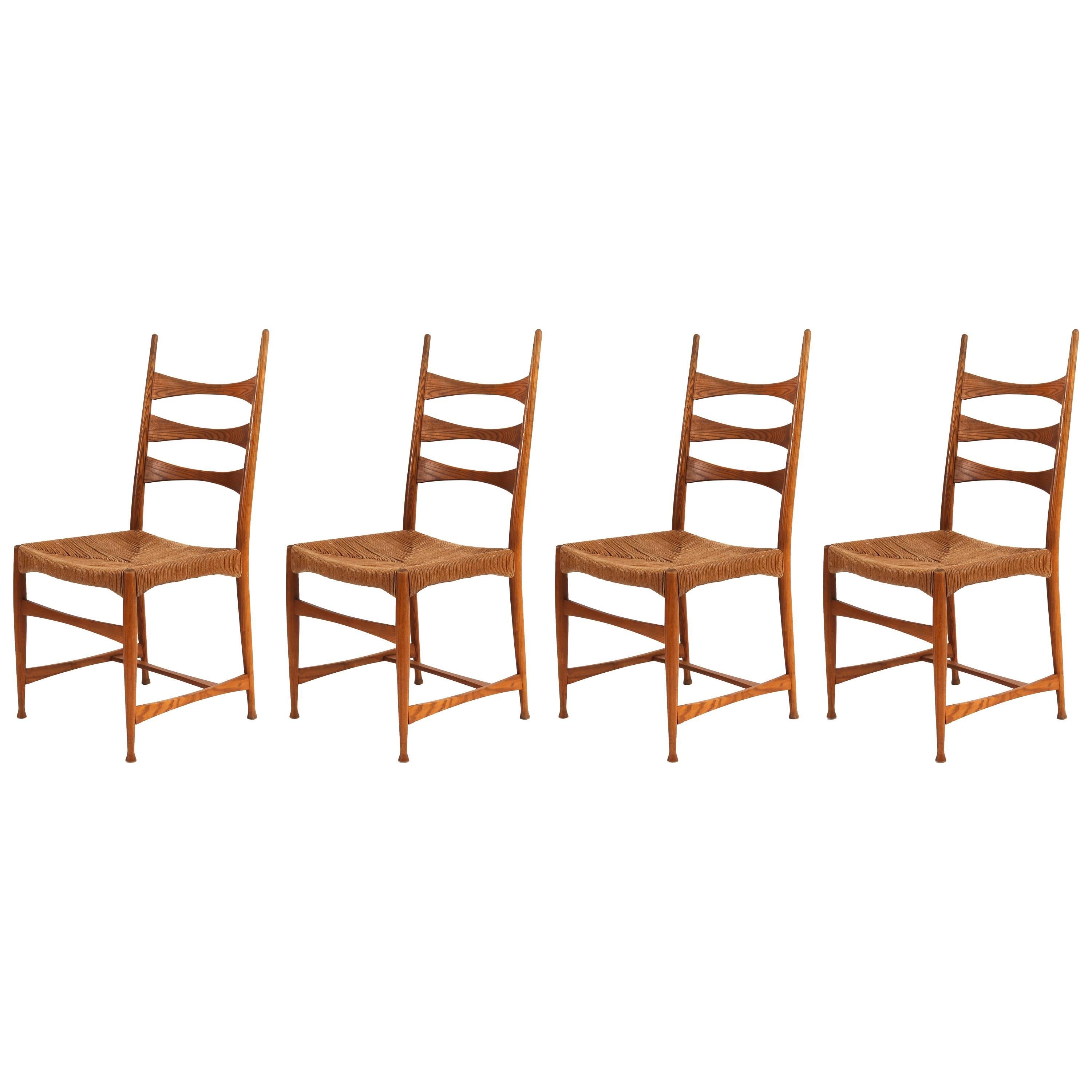 Four Paolo Buffa Sculpted Oak and Raffia Dining Chairs
