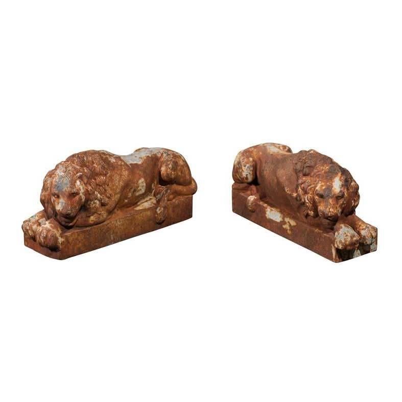 Pair of Petite French Patinated Iron Reclining Lions, Turn of the Century For Sale