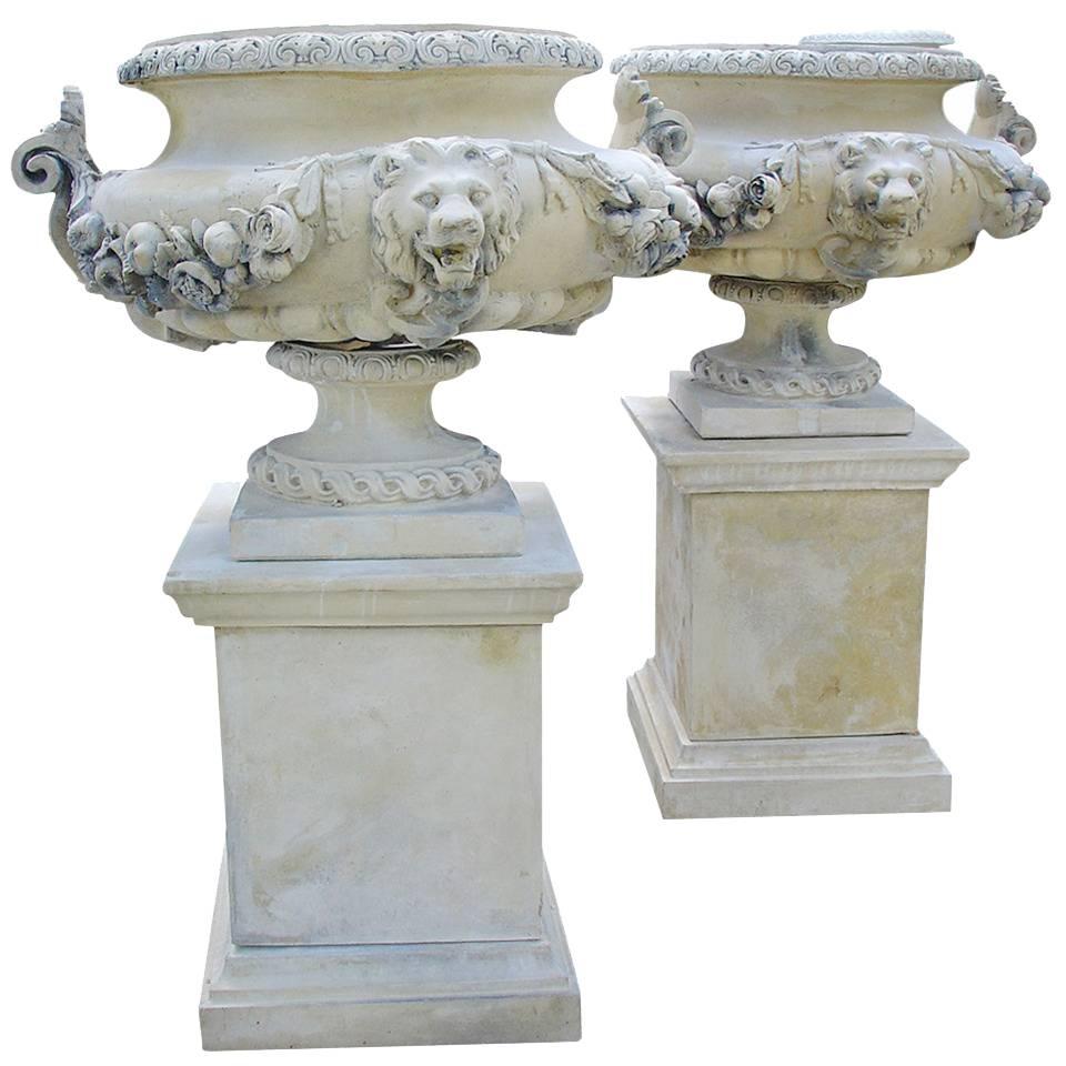 Pair of French Lion Urns on Pedestals