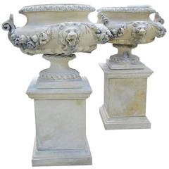 Pair of French Lion Urns on Pedestals