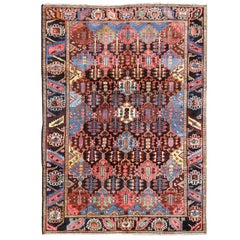 Tapis persan ancien Bakhtiari en anthracite, marron, bleu, jaune et vert