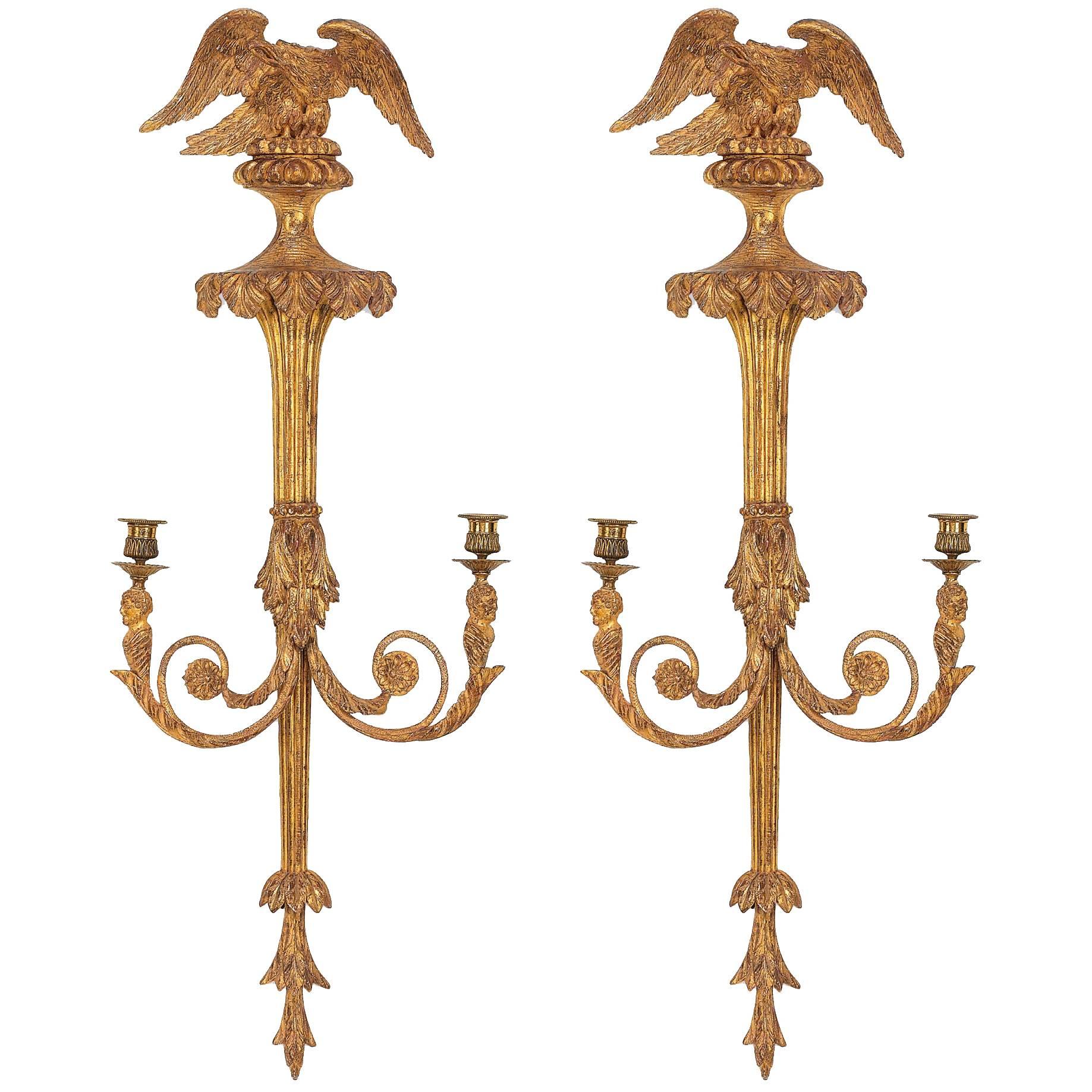 Pair of George III carved gilt-wood twin branch wall lights, late 18th Century
