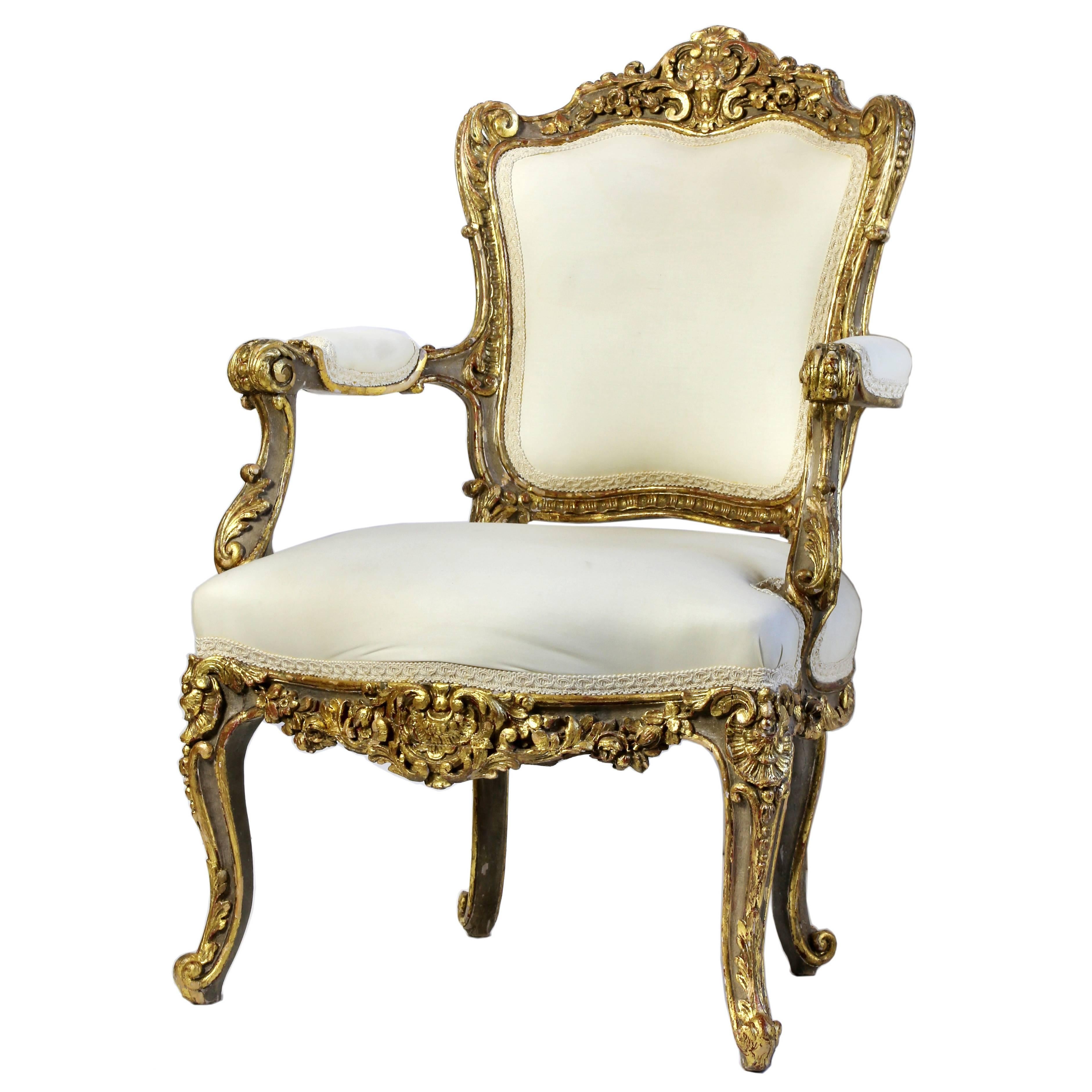 Italian Heavily Carved and Gilded Rococo Open Armchair For Sale