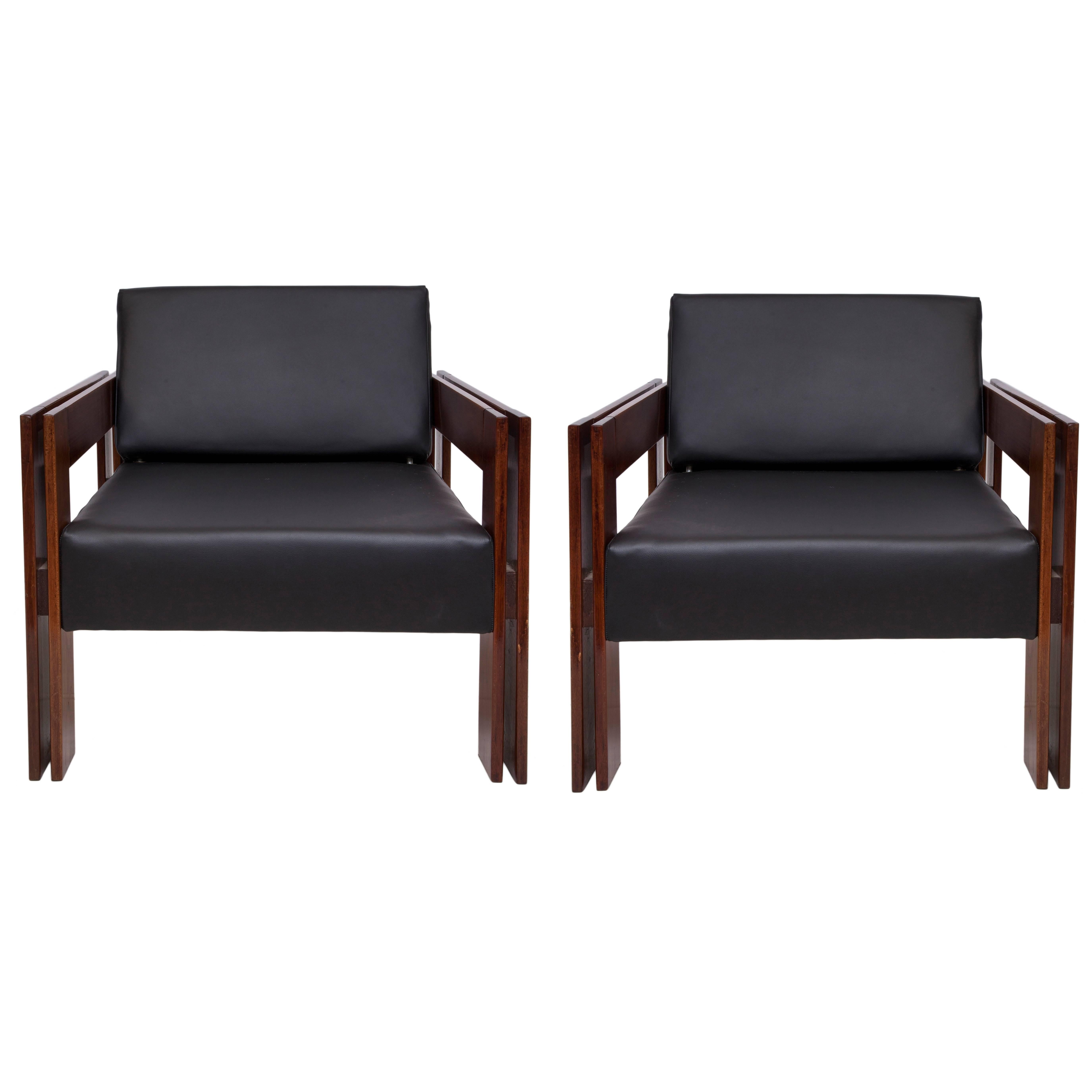 A pair of vintage circa 1960s armchairs by designer Percival Lafer, framed in Brazilian jacaranda wood, with seats and backs upholstered in black leather, which, when adjusted, can double as chaise lounges. Very good condition, consistent with age