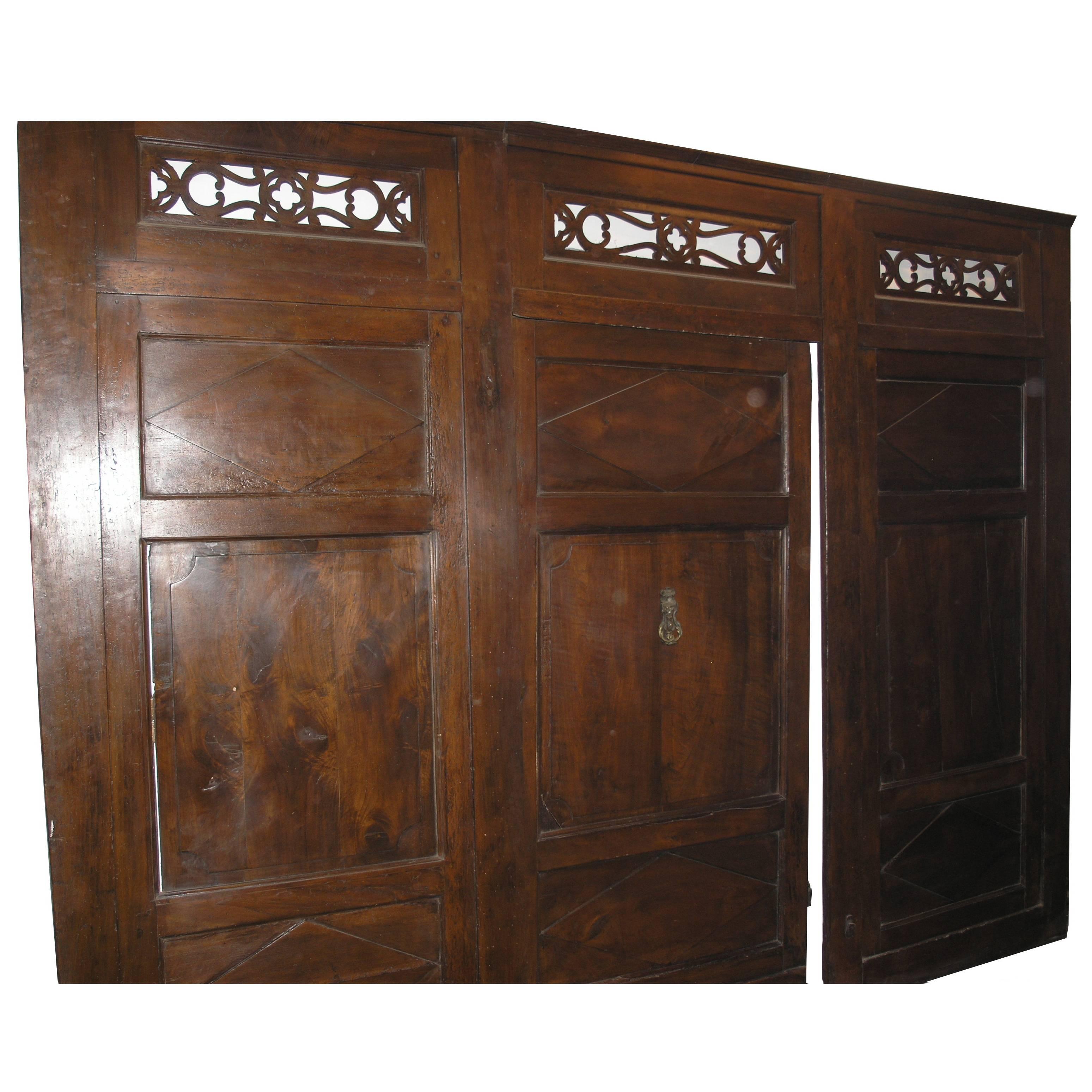 Italian Walnut entrance door with three doors, carved panels and central knocker, italy