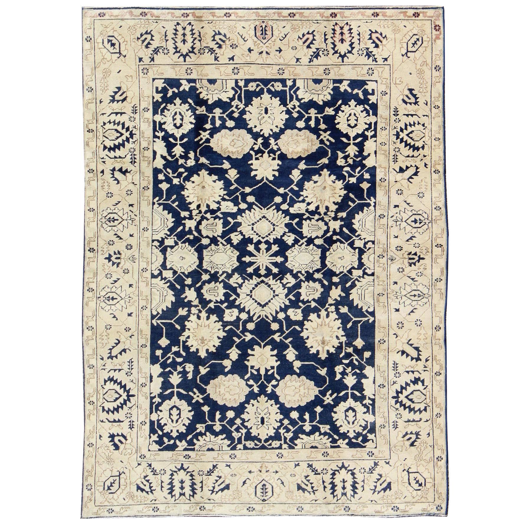 Unique Turkish Oushak Rug with Floral Design in Dark Blue, Cream and Light Brown For Sale