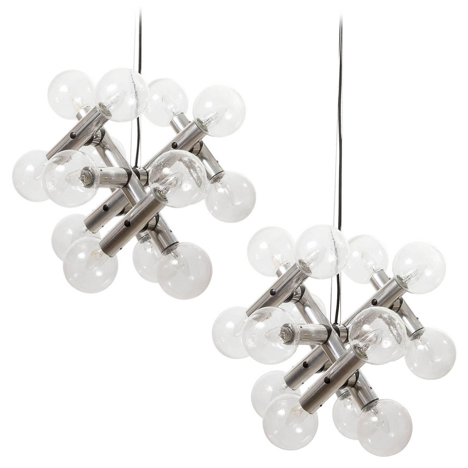 A set of three rare and fantastic 14-arm sputnik chandeliers / pendant lights model 'RS 14 HL' by Kalmar, manufactured in Mid-Century, circa 1970 (late 1960s or early 1970s). 
They are made of  polished aluminum and handblown bubble glass lamp