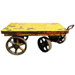 One industrial cart with handle and four iron wheels.